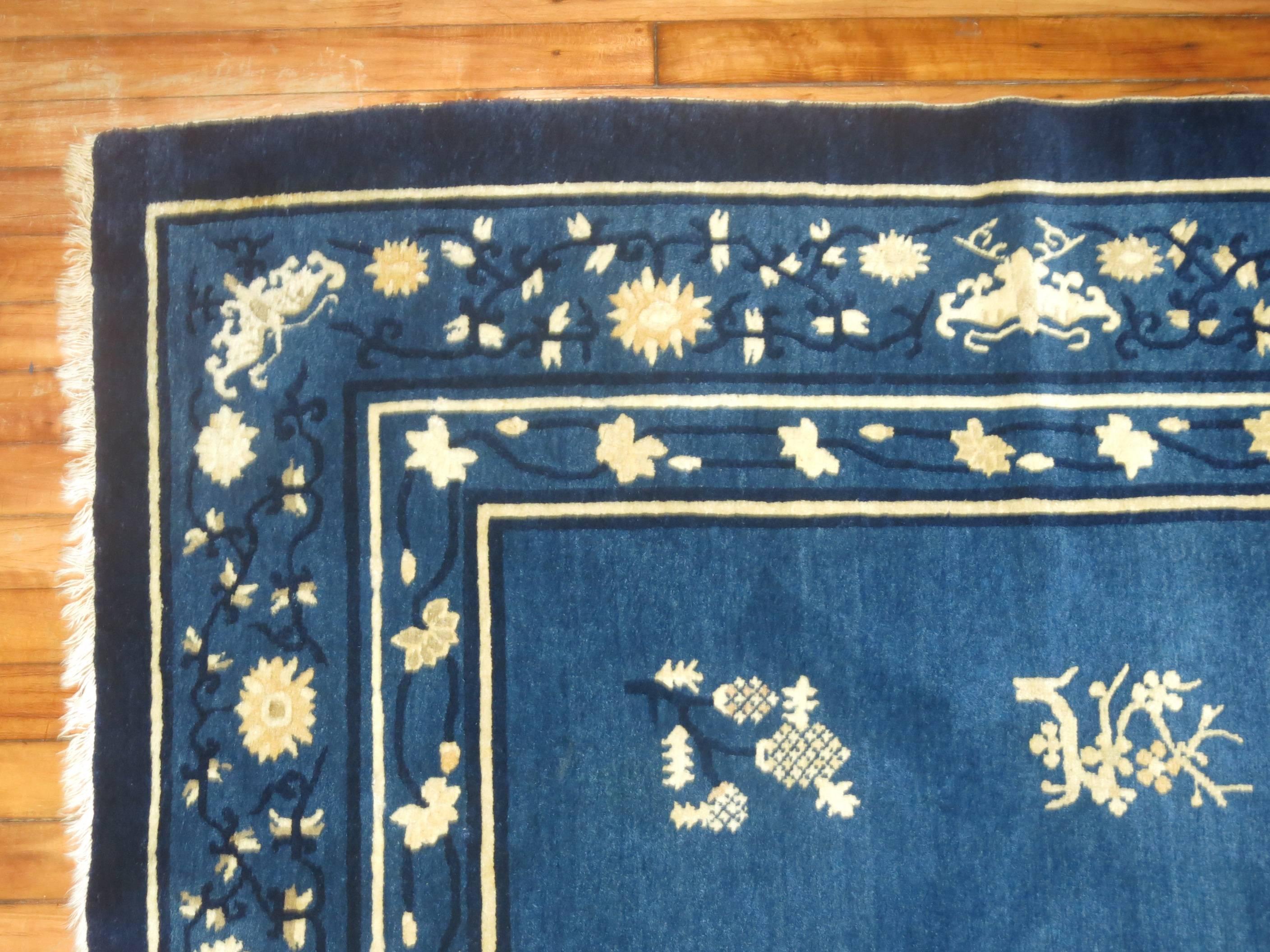Gorgeous Chinese Peking carpet with a floral motif on a blue ground and multiple border design. Even more attractive once seen in person.
