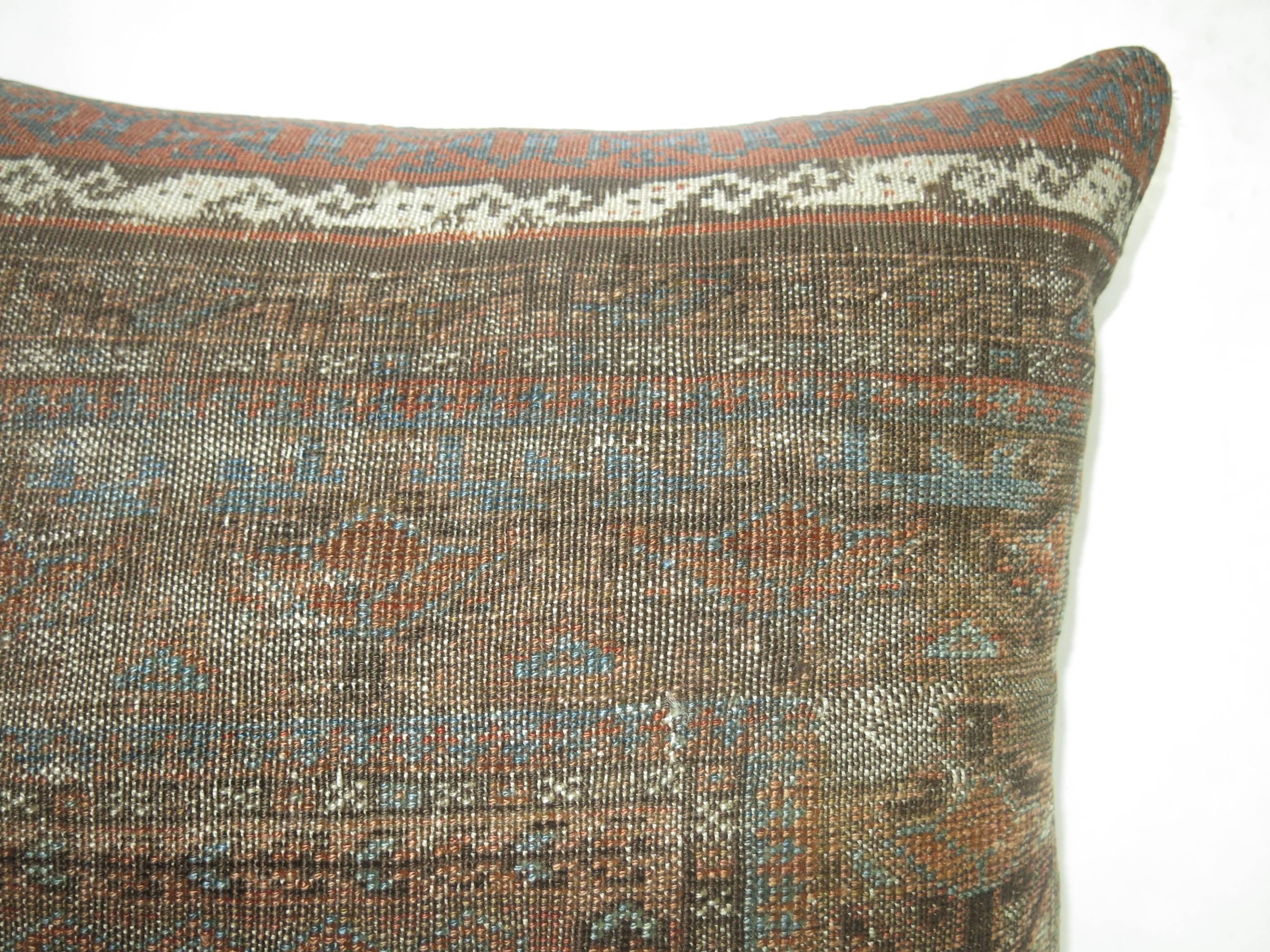 Pillow made from a brown, rust and blue ersari pillow.