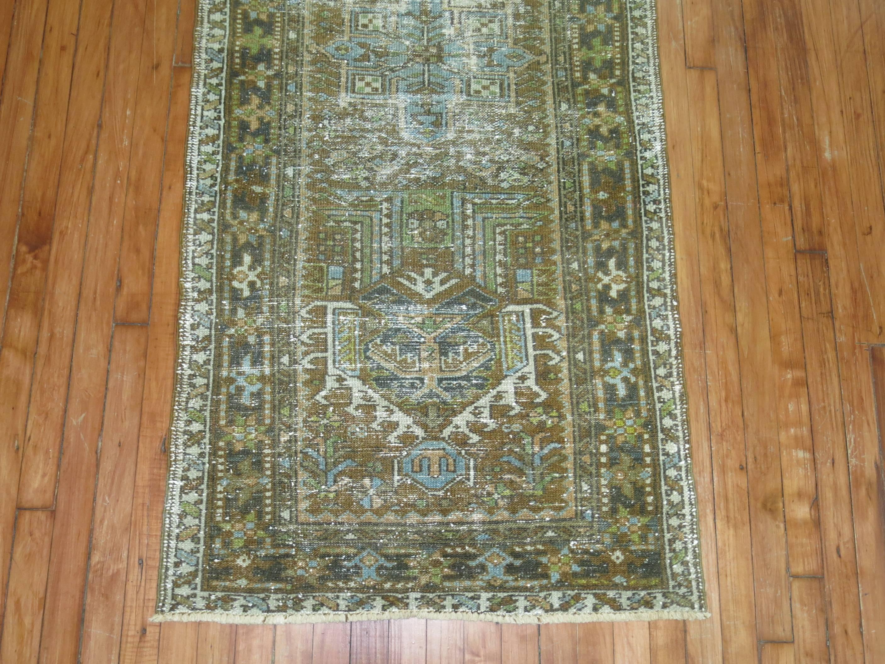 Persian Heriz Runner in predominant brown, accents in green and blue. 
  We love the  natural wear on this rug because it shows a real taste of the life that it's already lived,  Also shows it has a had a history and character which  truly makes it