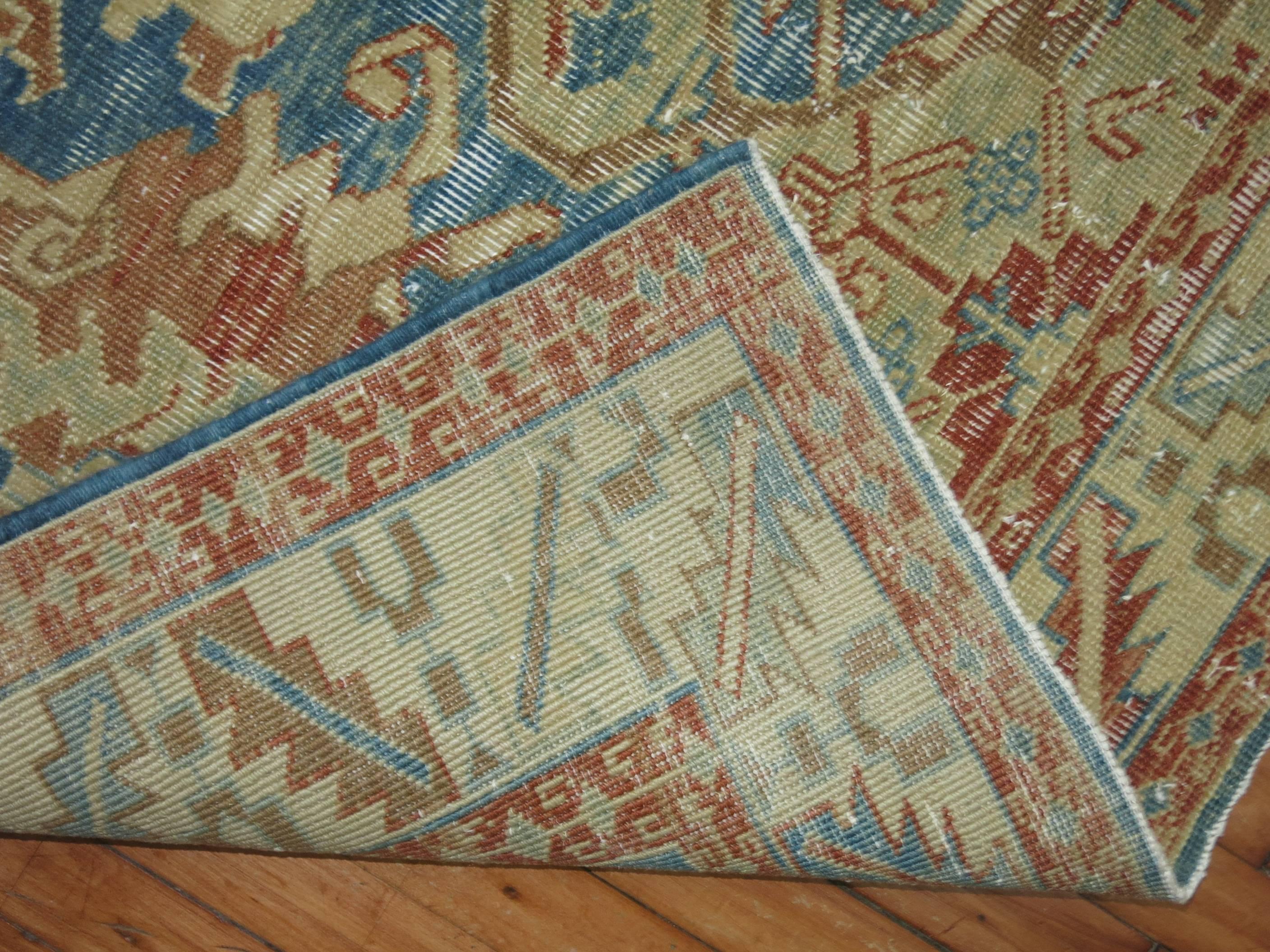 Mid-Century Persian rug with a weather texture feel in blues, rust, terracotta, beige and brown.