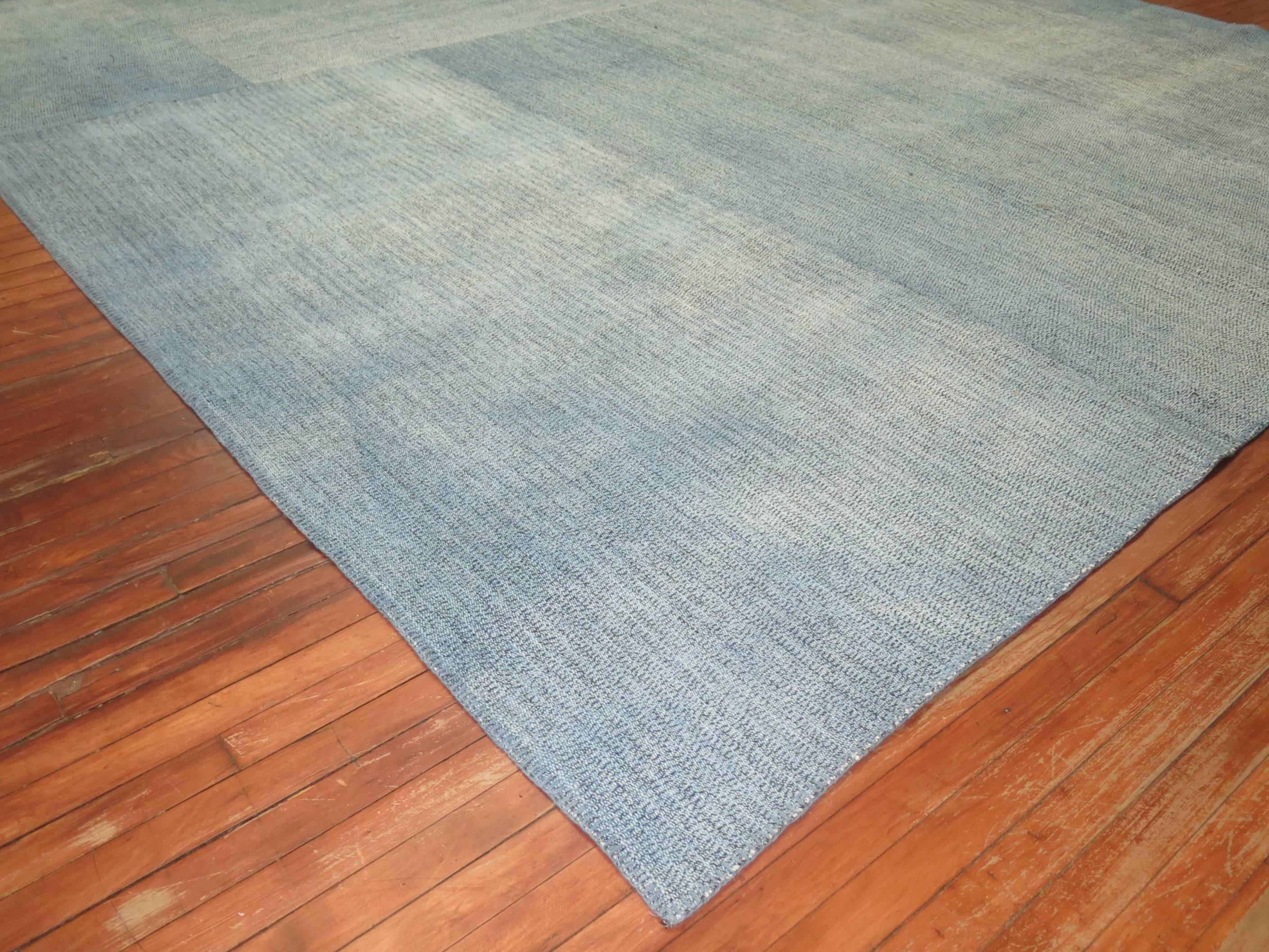 Square size hand-knotted Turkish Kilim in a blotchy aqua blue color. Handwoven by recycled cotton and goat hair material giving it an old world vintage feel.

10'10'' x 10'10''