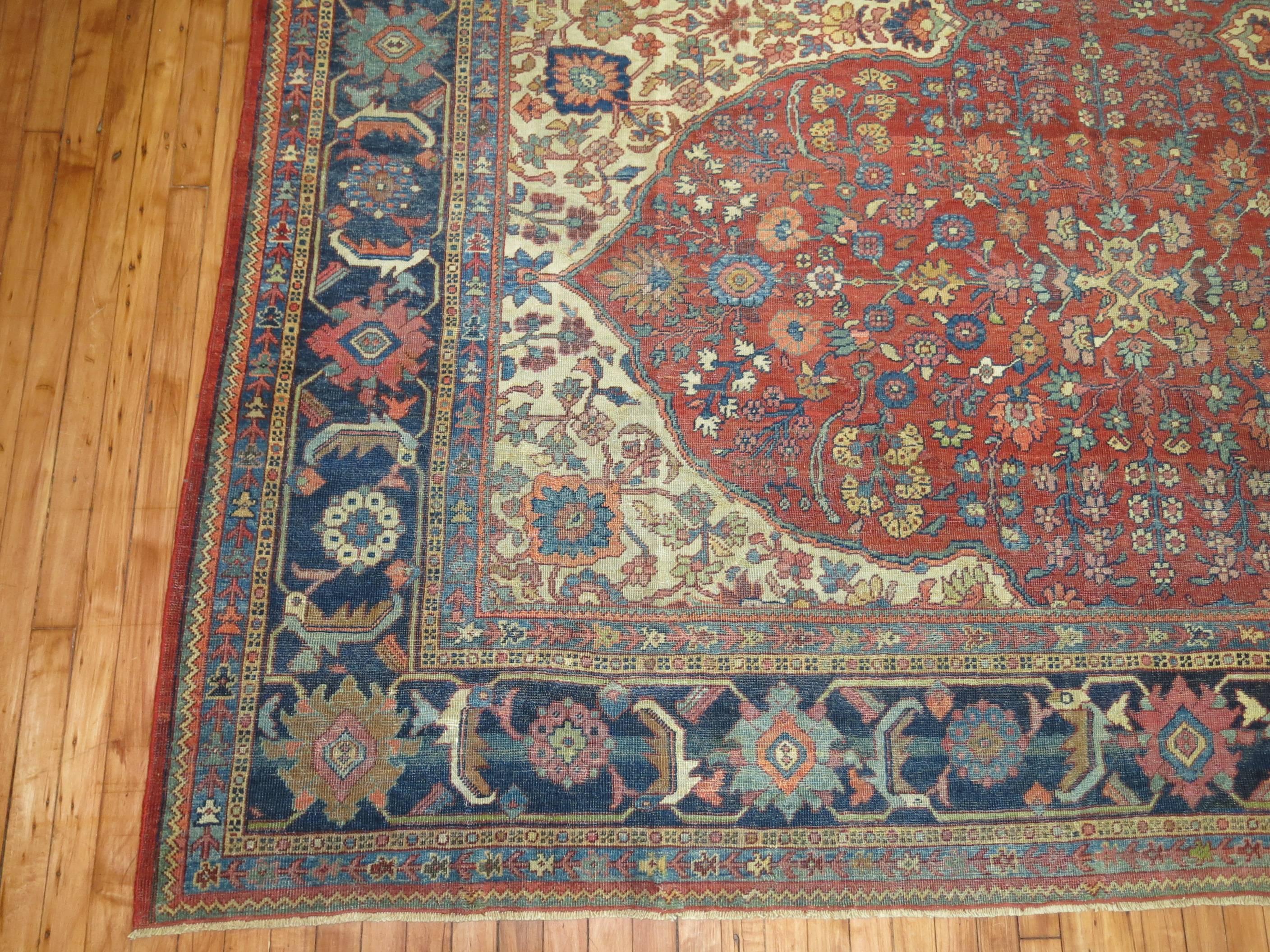 An early 20th century Persian Mahal rug with an obscure motif in reds and navy blues.

9'3'' x 12'6''