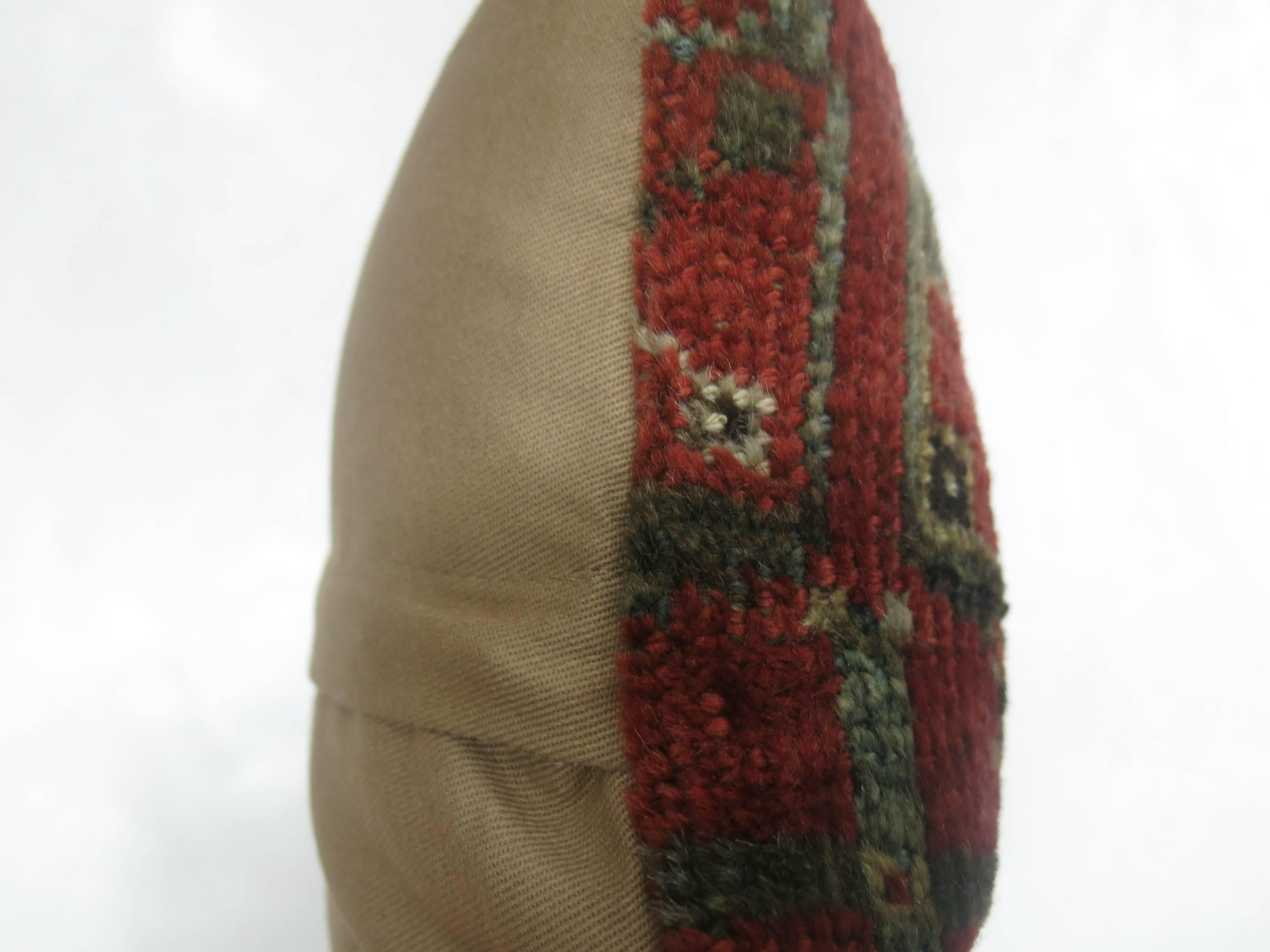 Bolster size pillow made from a 19th century Ersari rug.
