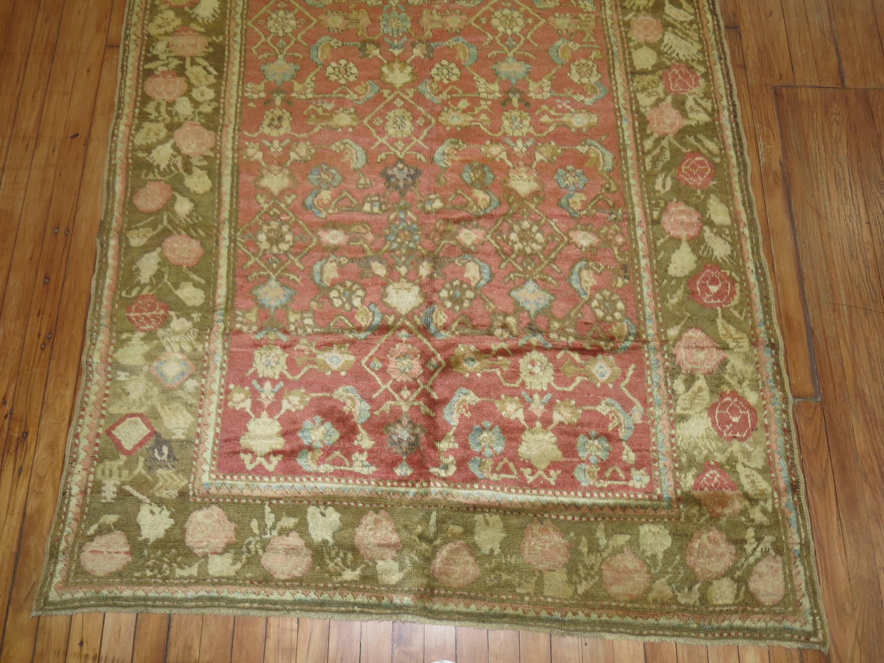 Plush pile Karabagh rug with an all-over Herati and floral design on a salmon colored field and a floral border in soft brown/ some accents in light blue sparkled in the field and border too.