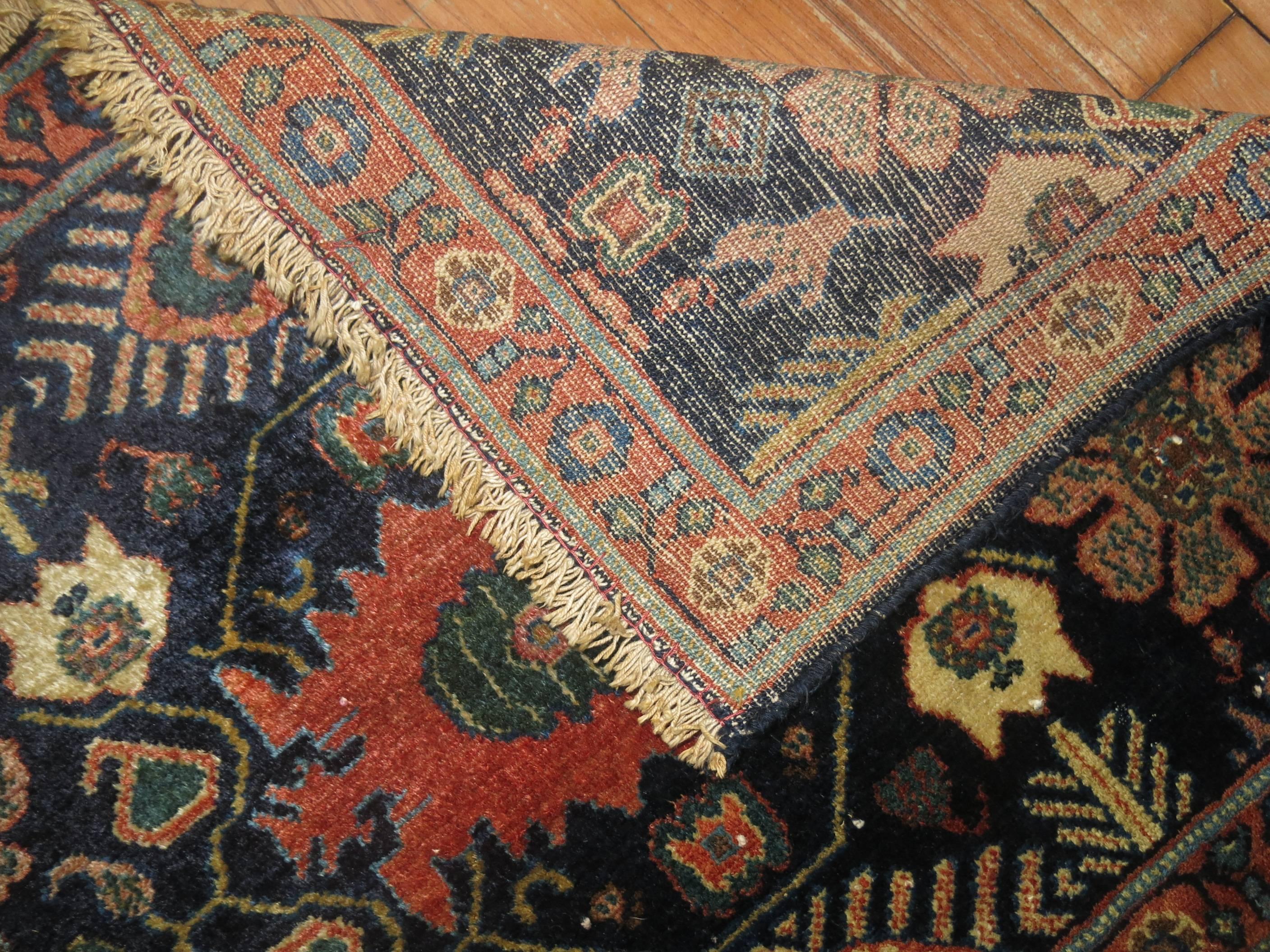 High quality Persian Senneh rug mat from the early stages of the 20th century. Navy blue ground with multi vibrant accents.