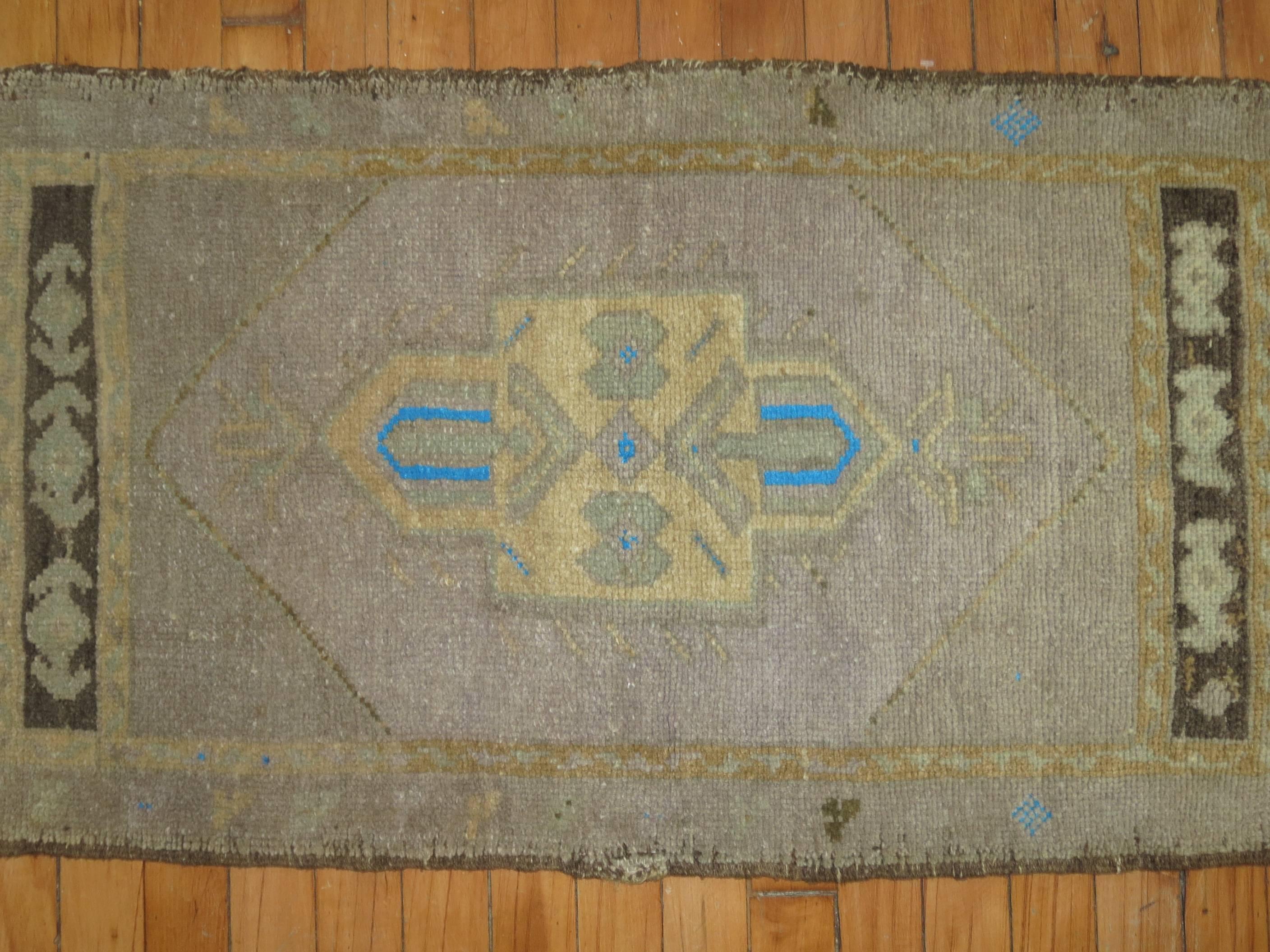 Midcentury Turkish Oushak featuring a pop of electric blue.

Measures: 1'9'' x 3'3''.