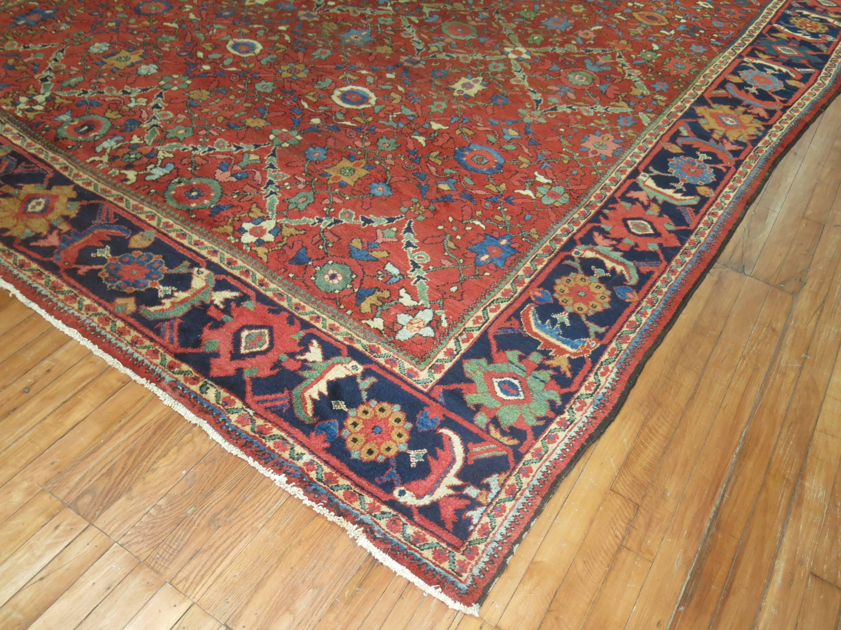 Fun, colorful room size early 20th century Persian Mahal carpet. Orangy red field with navy blue border.