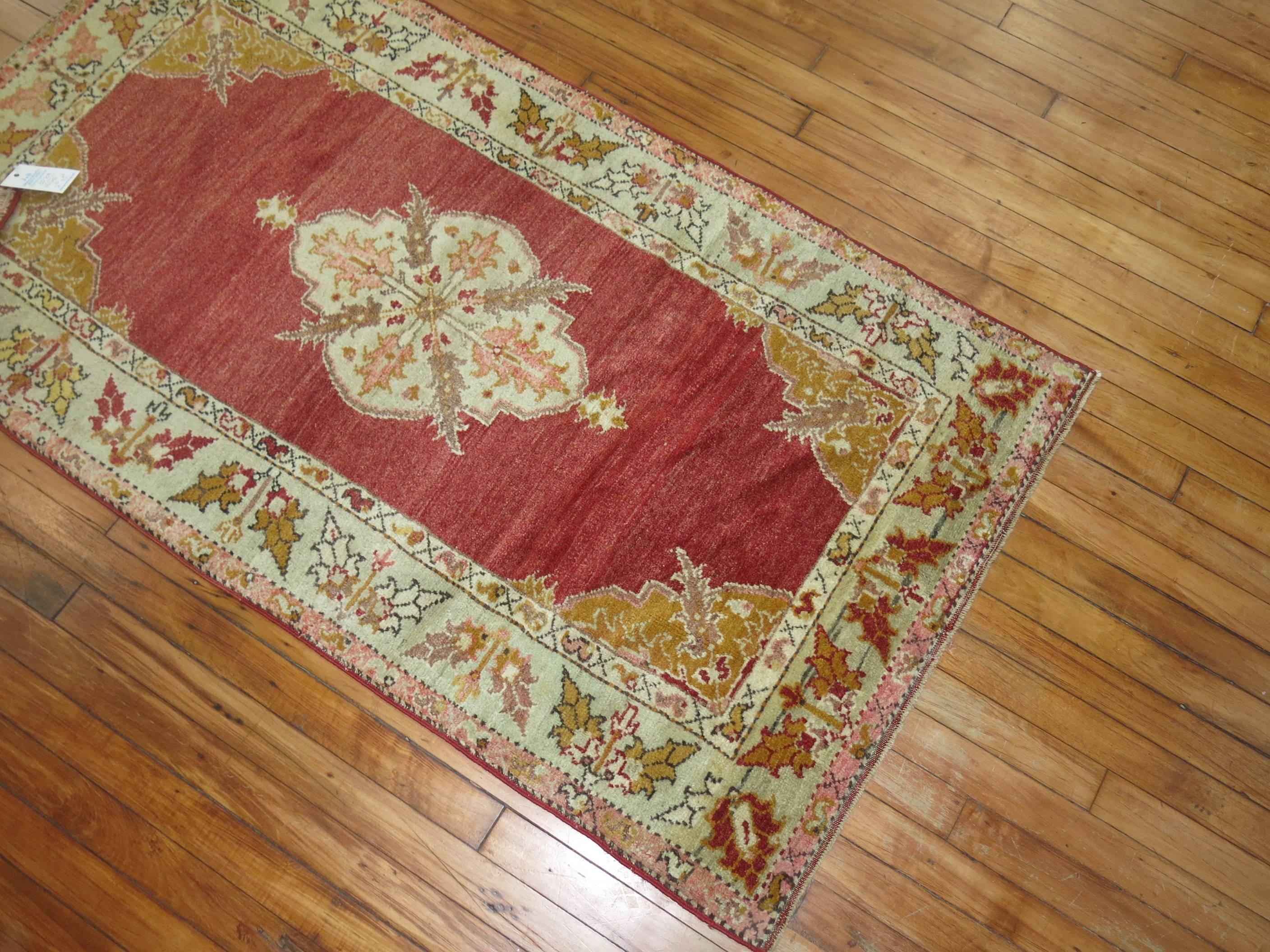 Fine quality early 20th century Turkish rug with a spacious red open field medallion design.