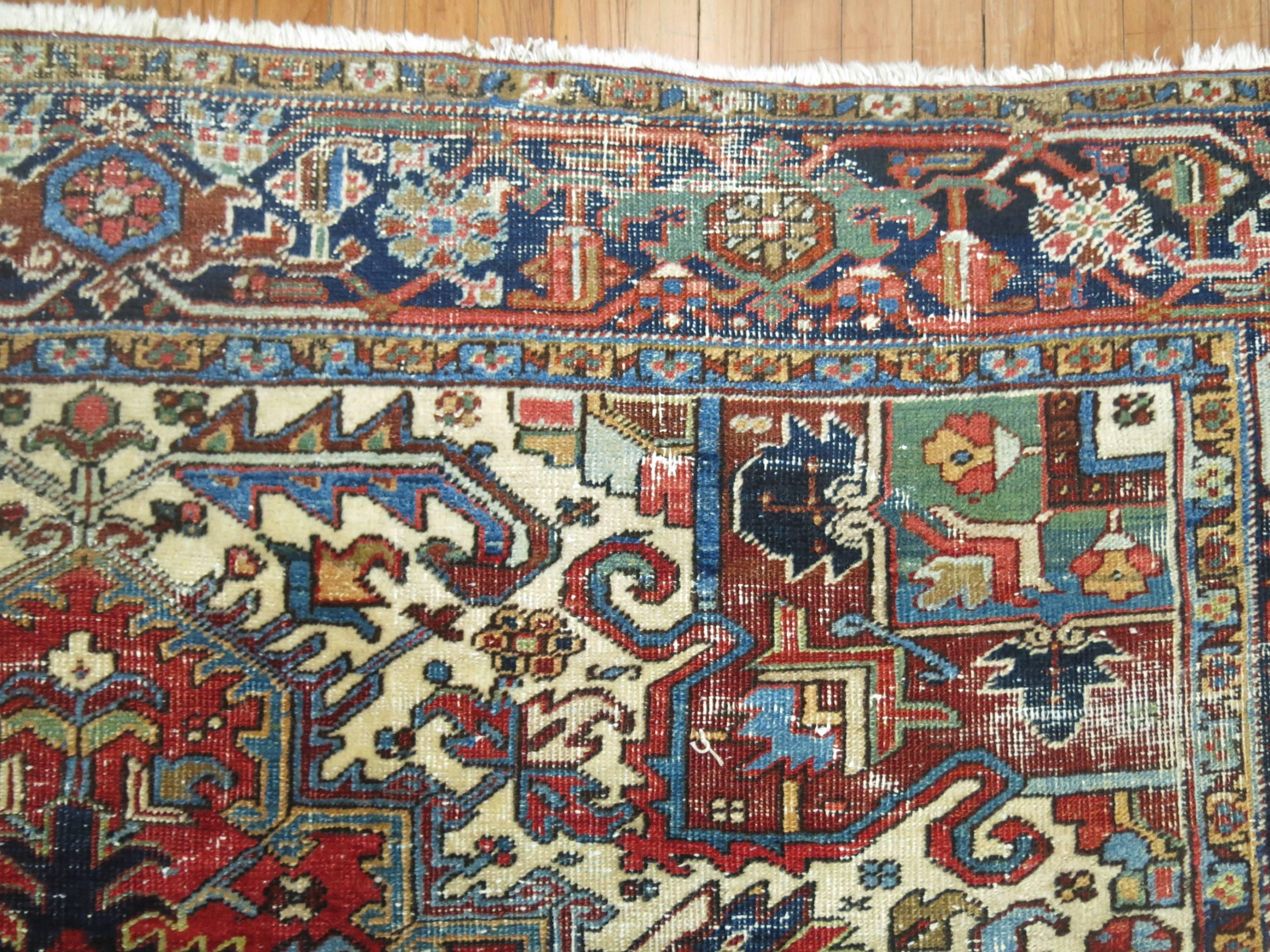 An early 20th century Classic Persian Heriz rug that has been distressed over time. Rug has been professionally cleaned. No holes, stains and can withstand everyday traffic.

Measures: 8'2”x 10'8”.