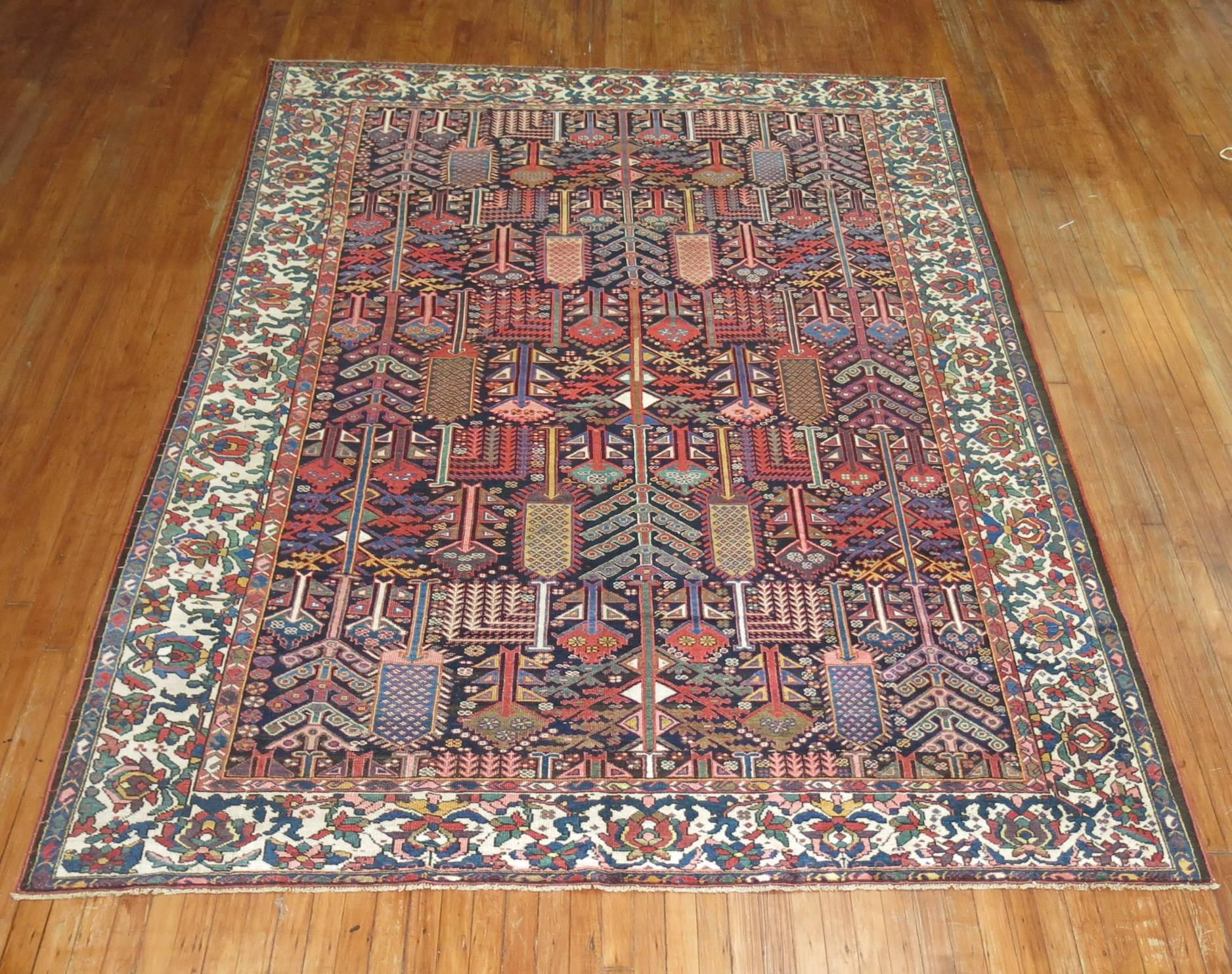 Lovely Persian Bakhtiari carpet depicting an all-over will tree design on a navy blue ground.