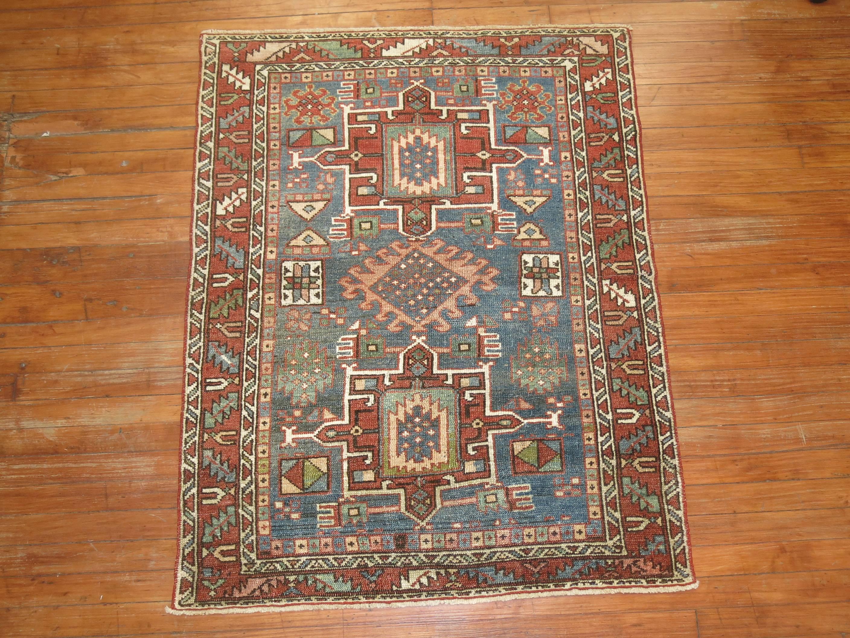 Throw size Persian Karadja Heriz rug with a soft denim blue field with other rustic colors.

Measures: 3'4'' x 4'3'.