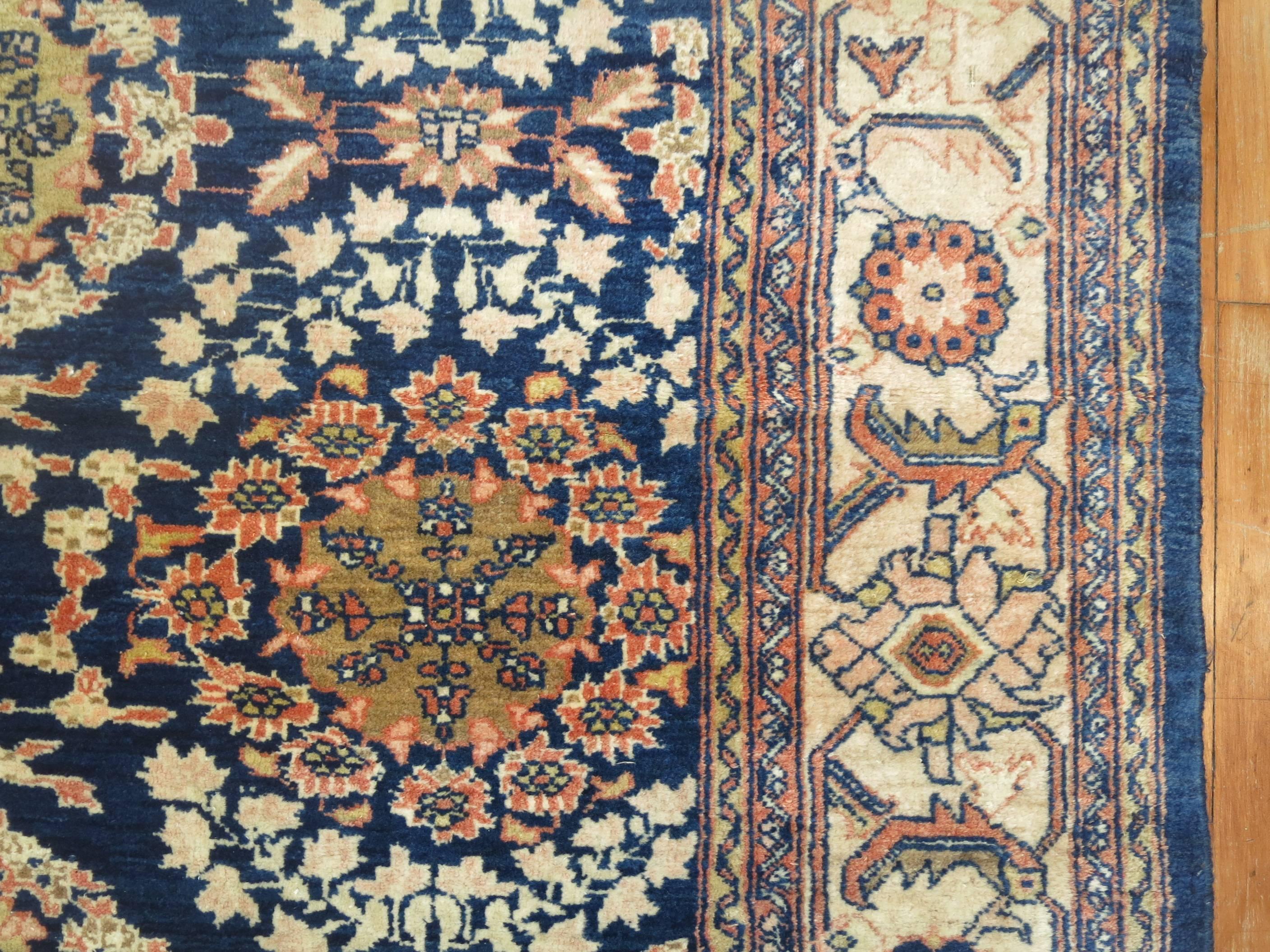 Room size Persian Mahal rug with a blue field and ivory border.

Mahal Persian carpets from the 19th century and turn of the 20th century have become one of the most desirable among Persian village weavings, as they appeal strongly to both