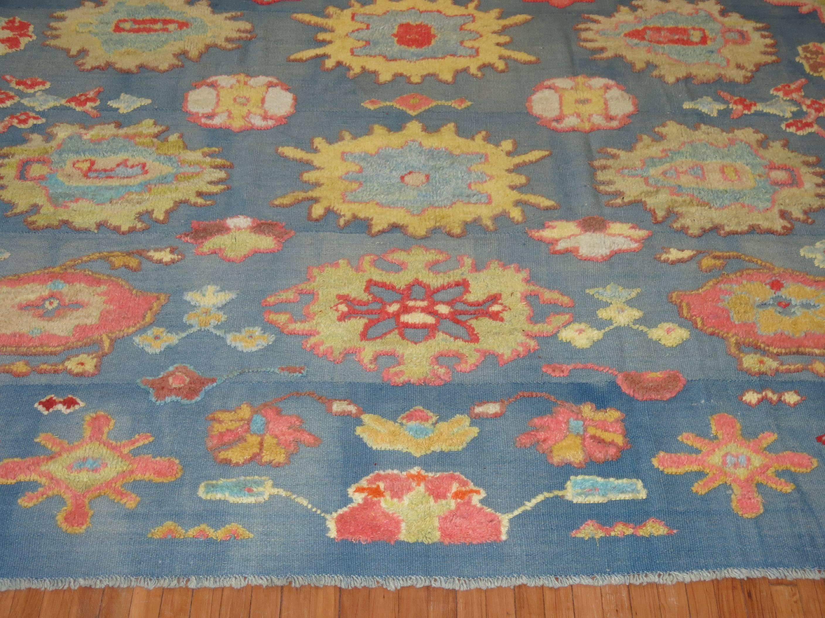 One of a kind Turkish flat-weave with a handwoven raised wool pile used from mid-20th century Turkish Tulu rugs to form its design on a blue colored ground.