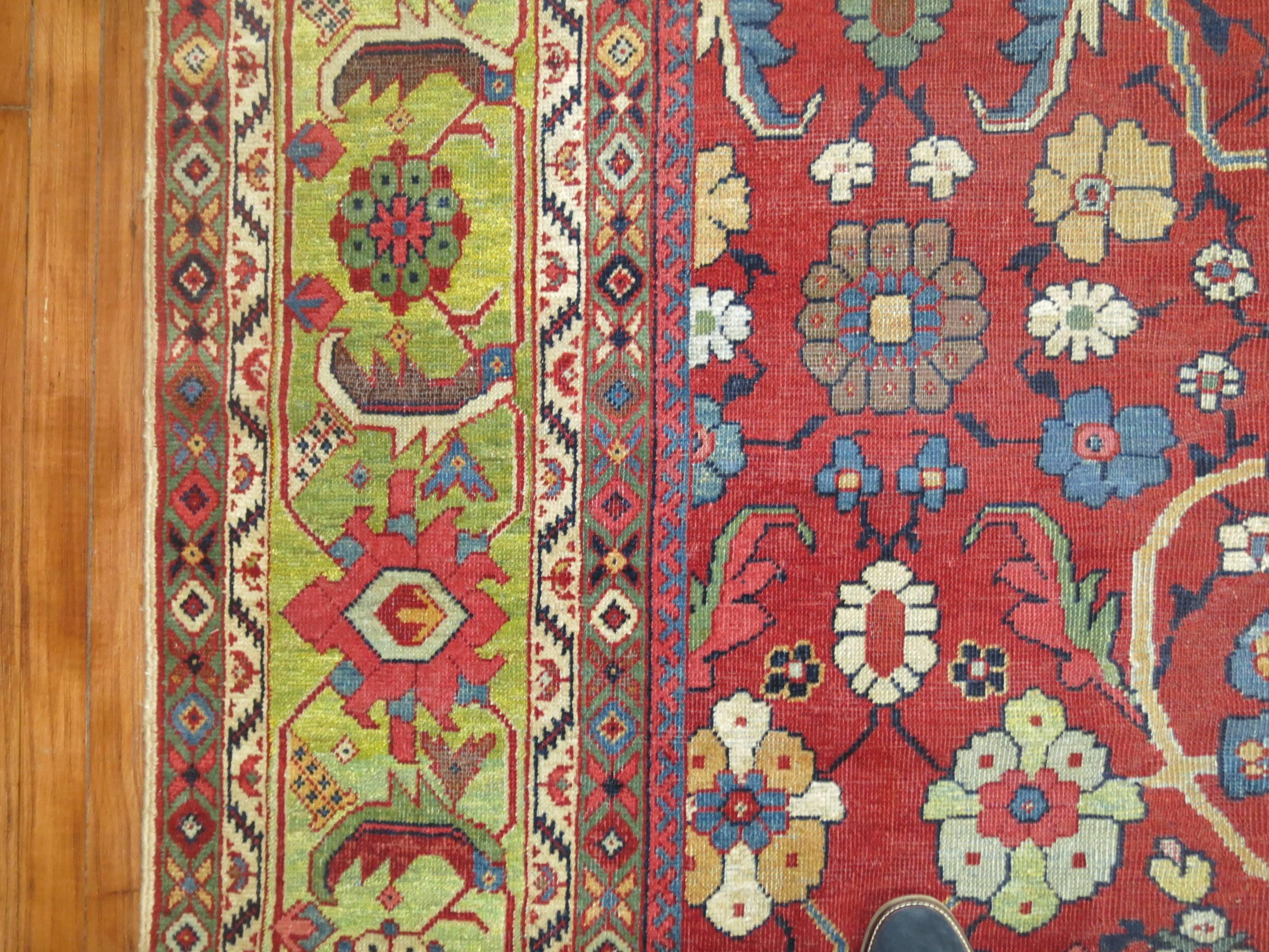 An early 20th century Persian Mahal rug with a red ground and light green abrashed border.

Exemplary oversize Mahal antique carpets are preferred by many for their originality and inspired artistry and have forged an important niche in today’s