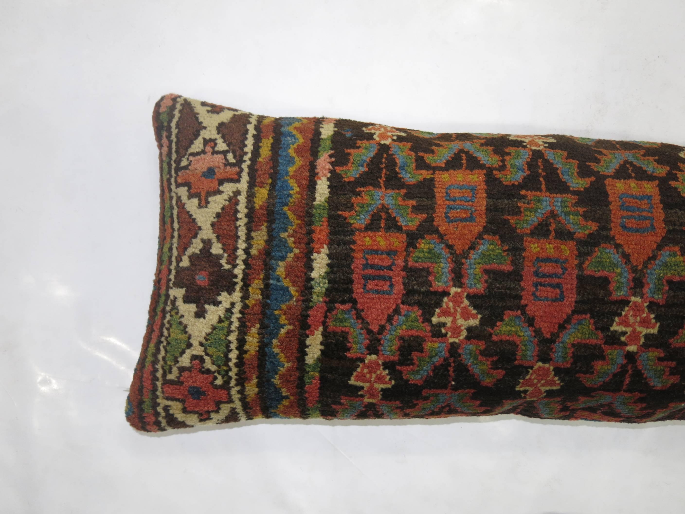 Bolster pillow made from a 20th century Northwest Persian rug.
