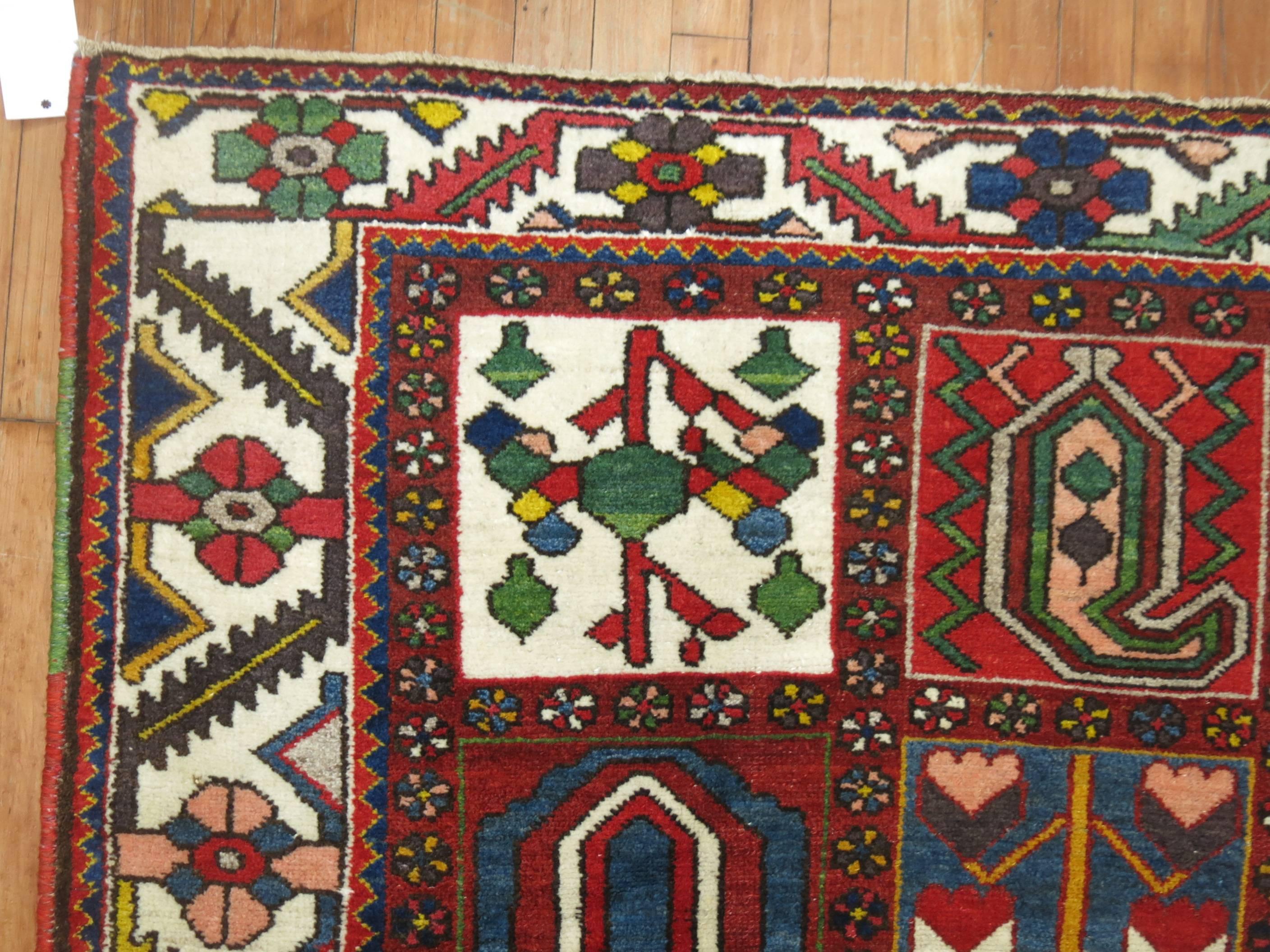 Colorful Persian Bakhtiari carpet with traditional panel design. The weaver added colorful salvage to each side too giving it an added characteristic.

4'7'' x 7'2''