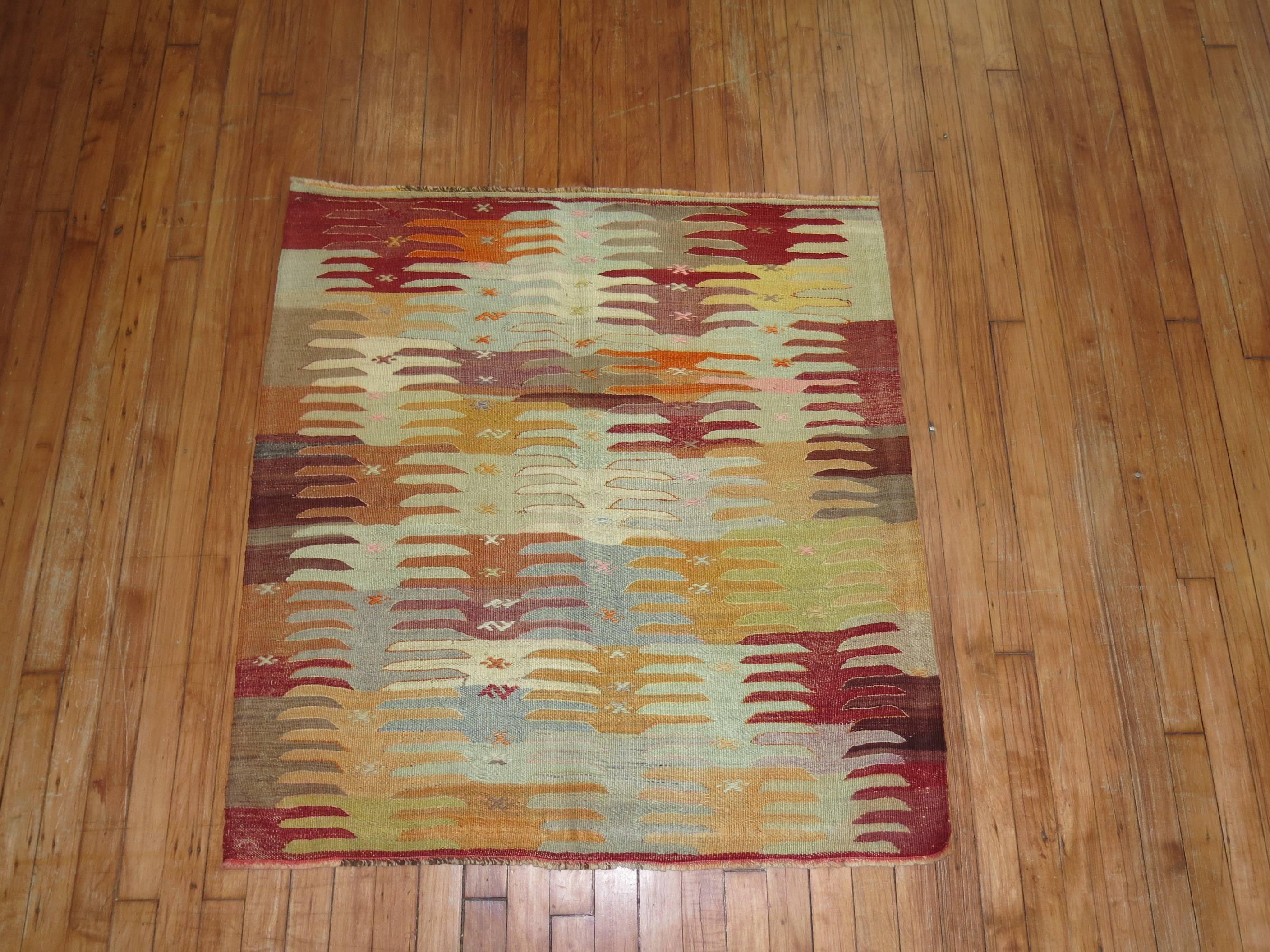 Throw size Turkish Kilim flat-weave. Measures: 3'4'' x 3'6''.