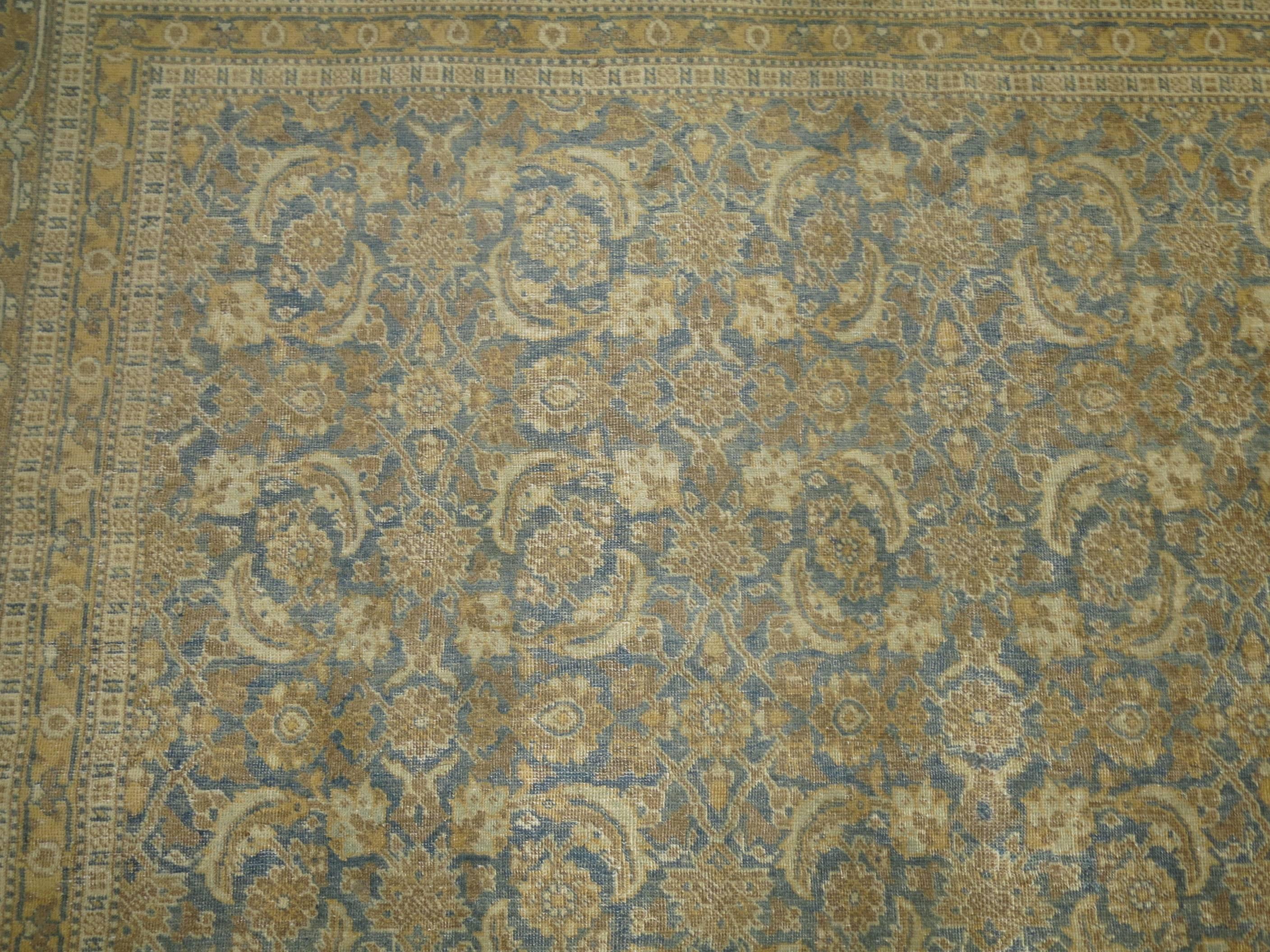 Persian Tabriz with Classic all-over herati design. Soft blue field with predominant accents in brown and gold.