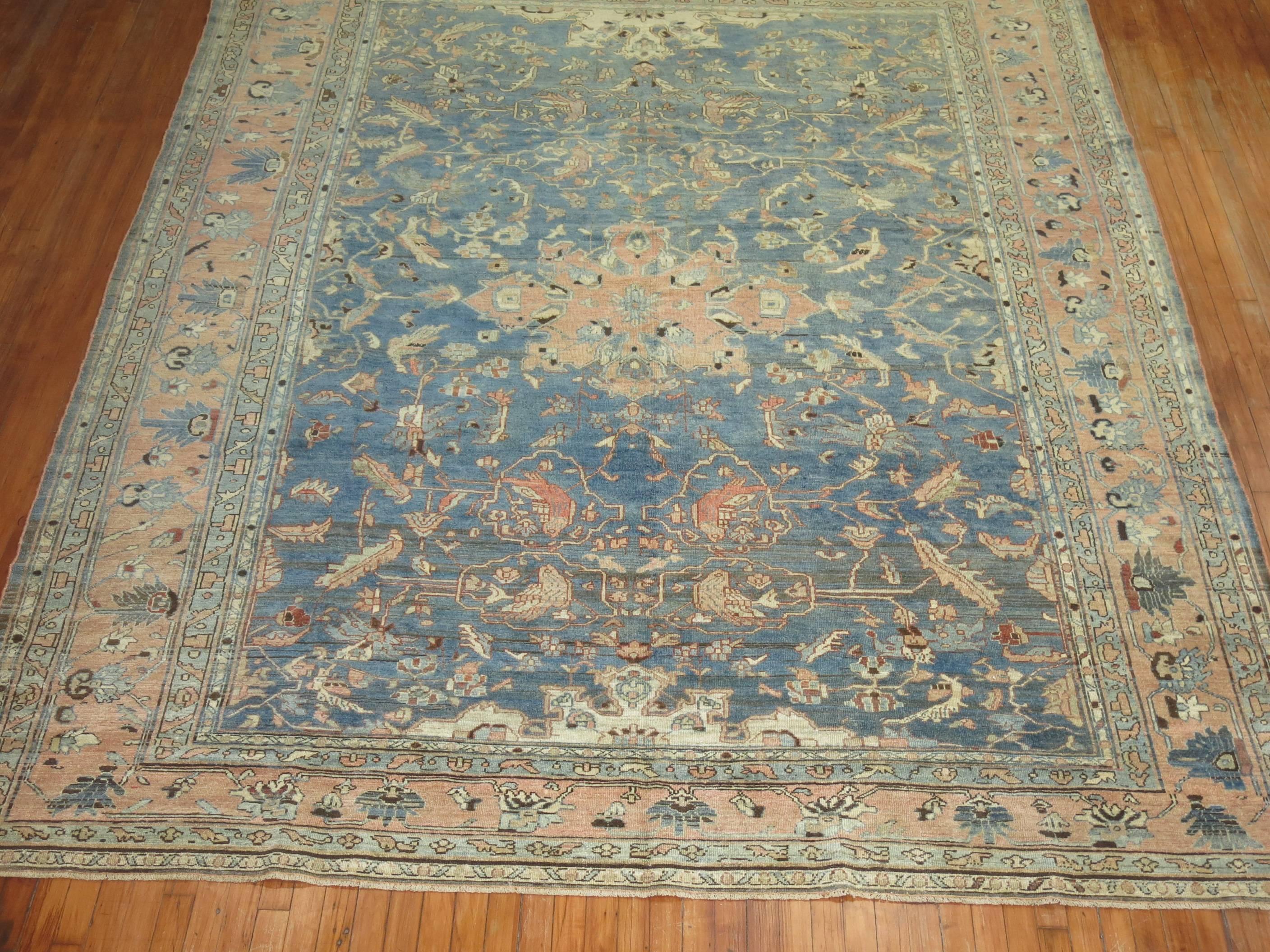 An early 20th century Persian Malayer rug. Abrashed blue field and terracotta border. A few pigeons are spotted in the field, circa 1920.

Measures: 8'11'' x 11'3''.