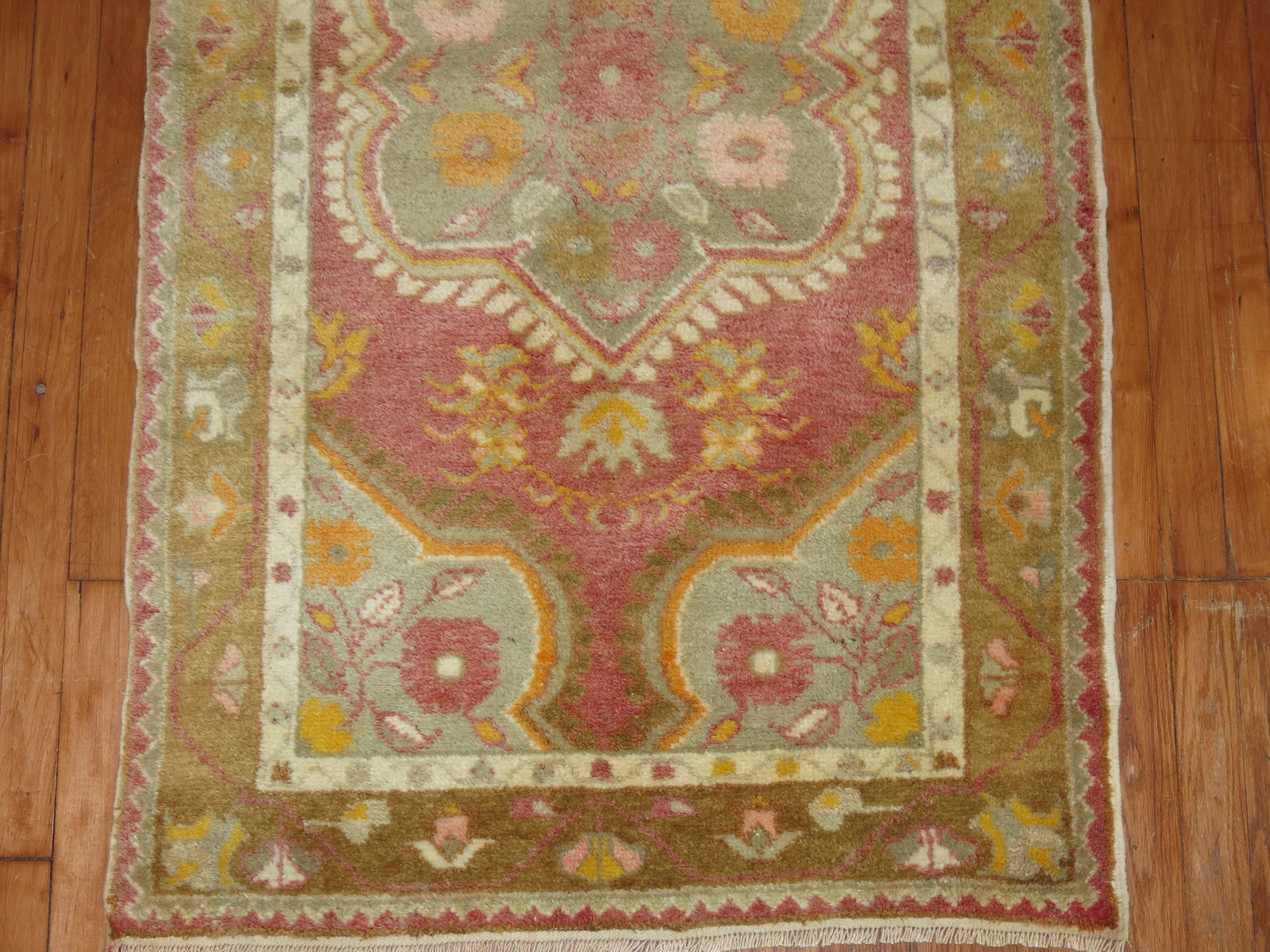 Pink colored vintage Turkish Oushak rug.