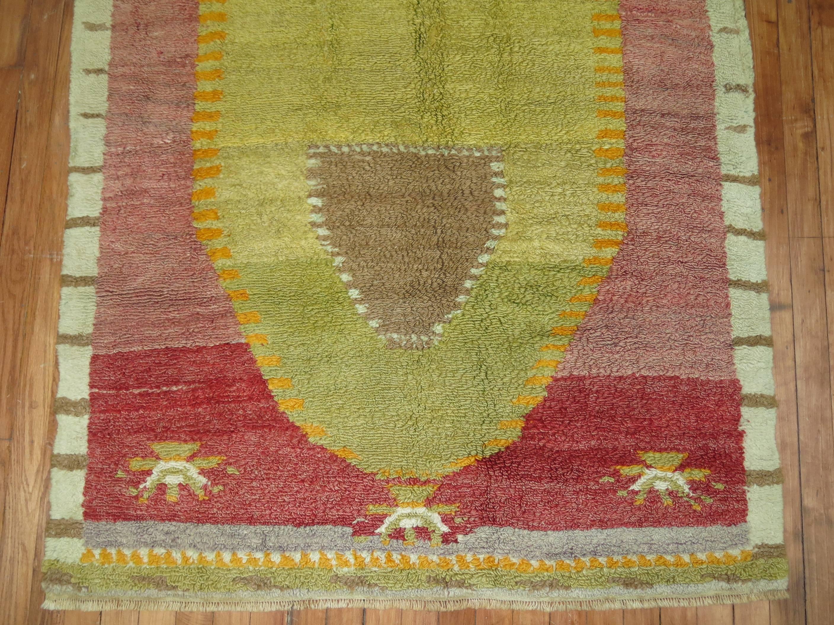 Turkish Tulu rug with an interesting green medallion on a soft red colored ground.