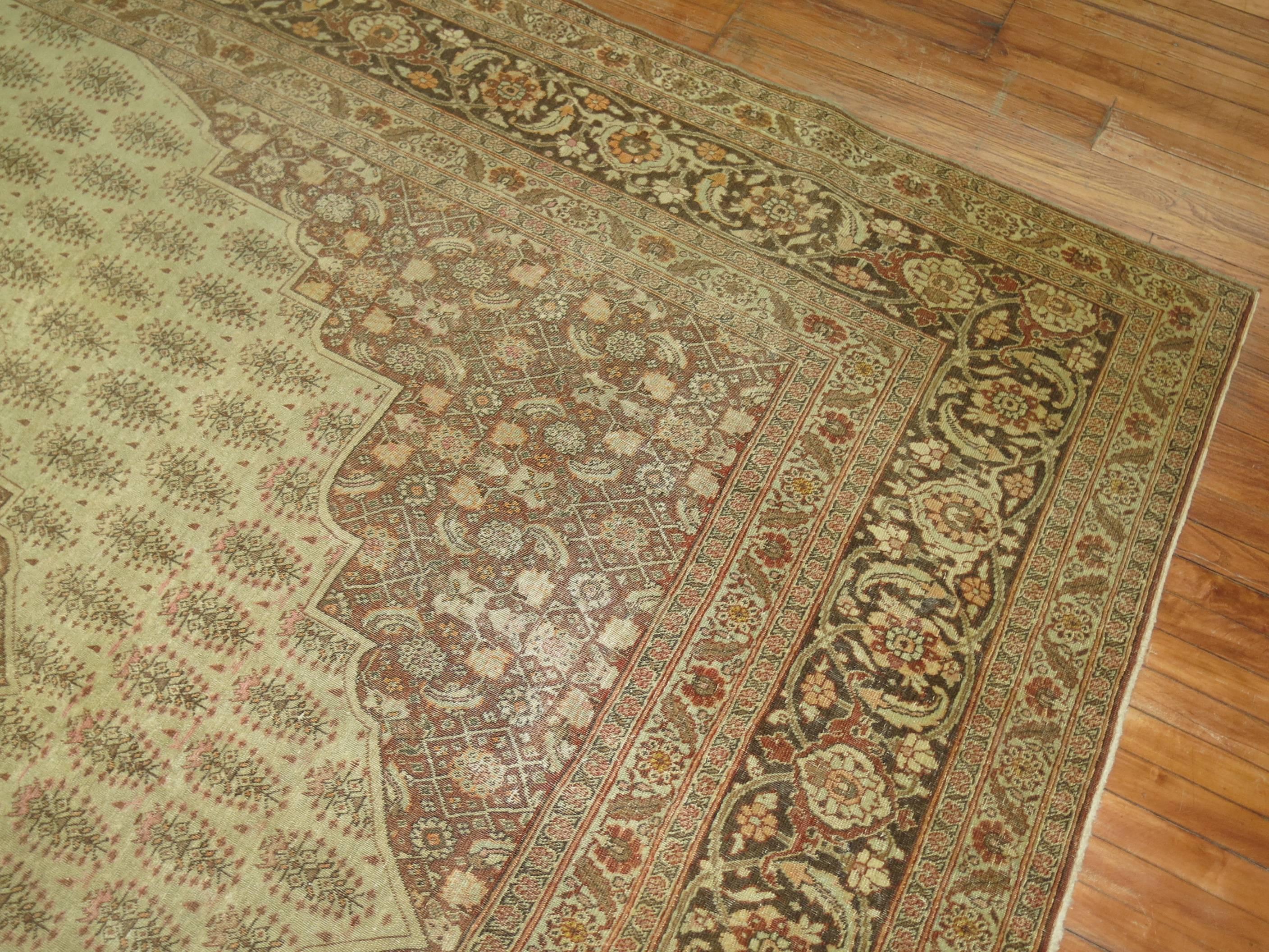 An early 20th century Persian Tabriz rug in predominant shades of brown and beige,

circa 1920. Measures: 9'1