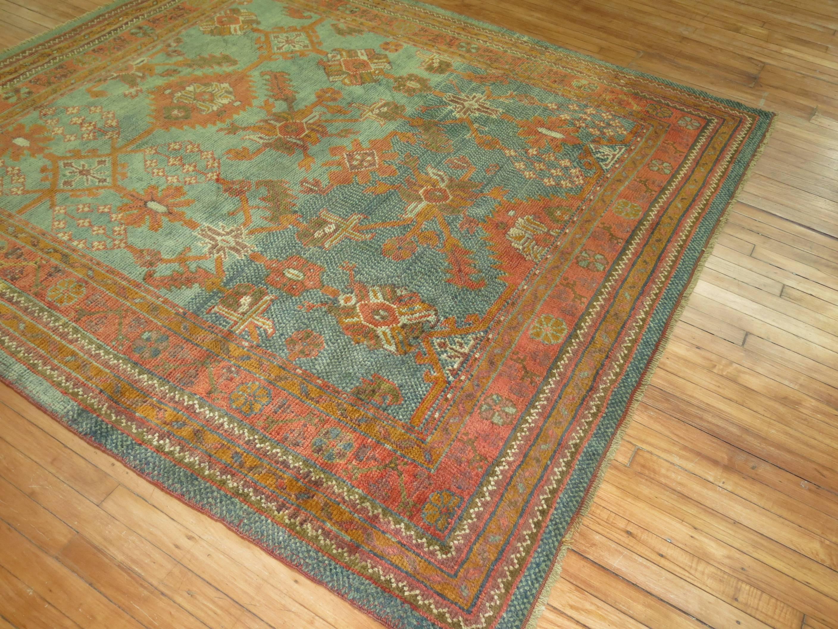 Rare size abrashed antique Oushak rug in oranges and green.

7' x 7'9''