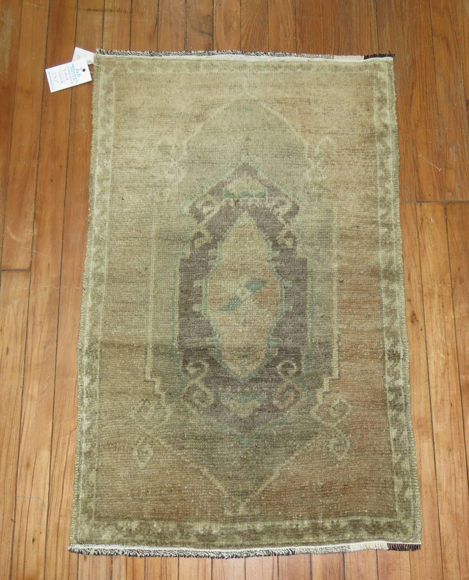 Vintage Turkish Oushak rug with soft muted tones.