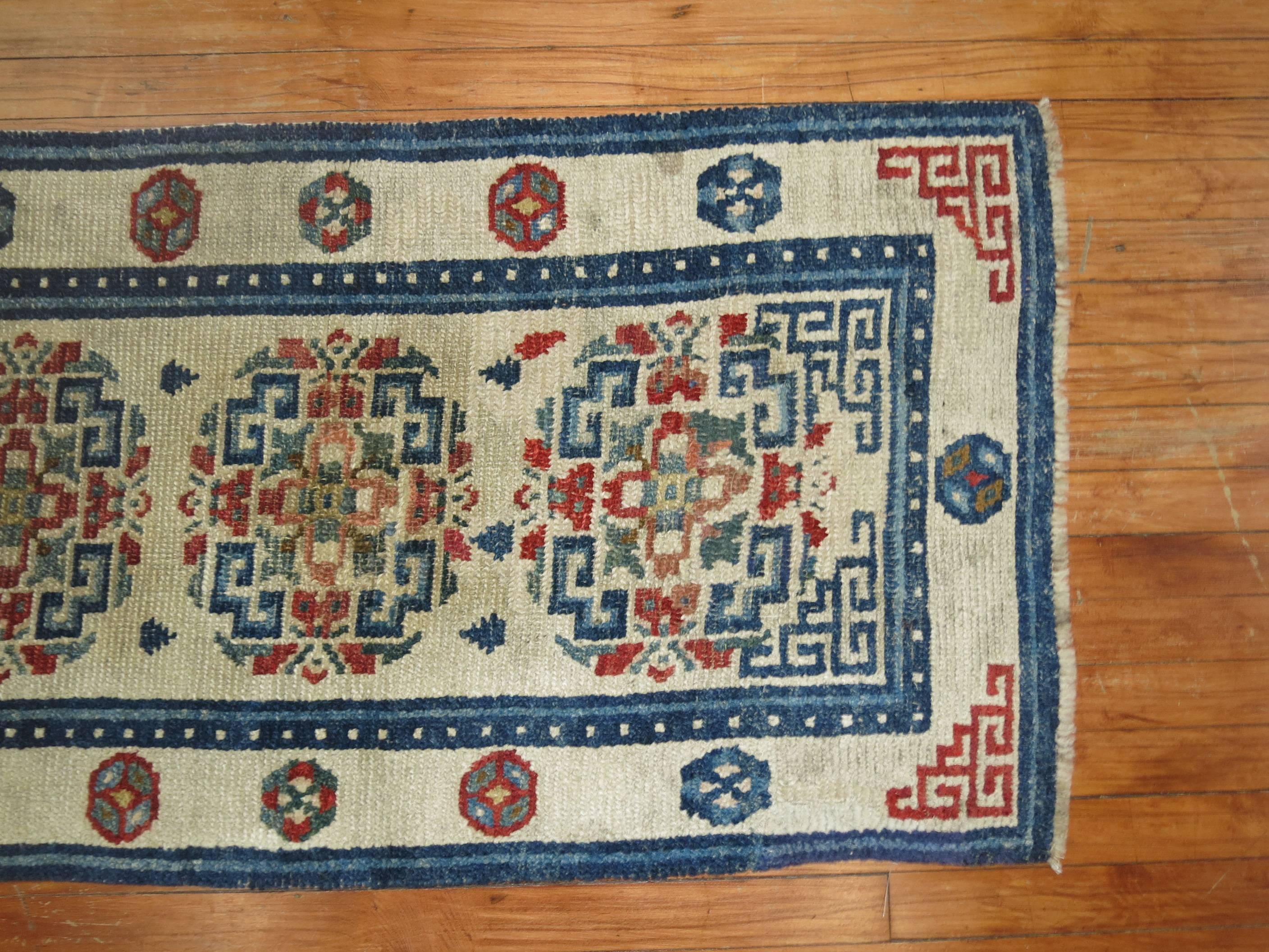 An early 20th century antique Tibetan rug in predominant white and blue accents.