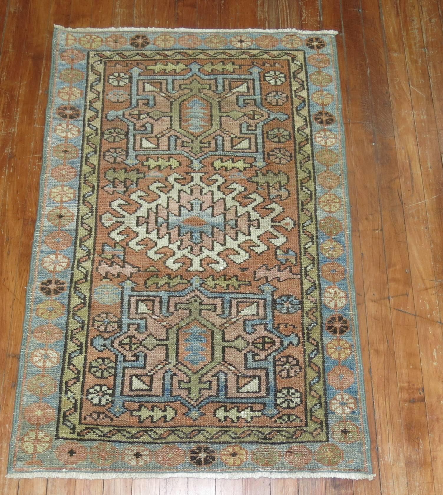 Antique Persian Heriz throw size rug featuring sky blue accents.