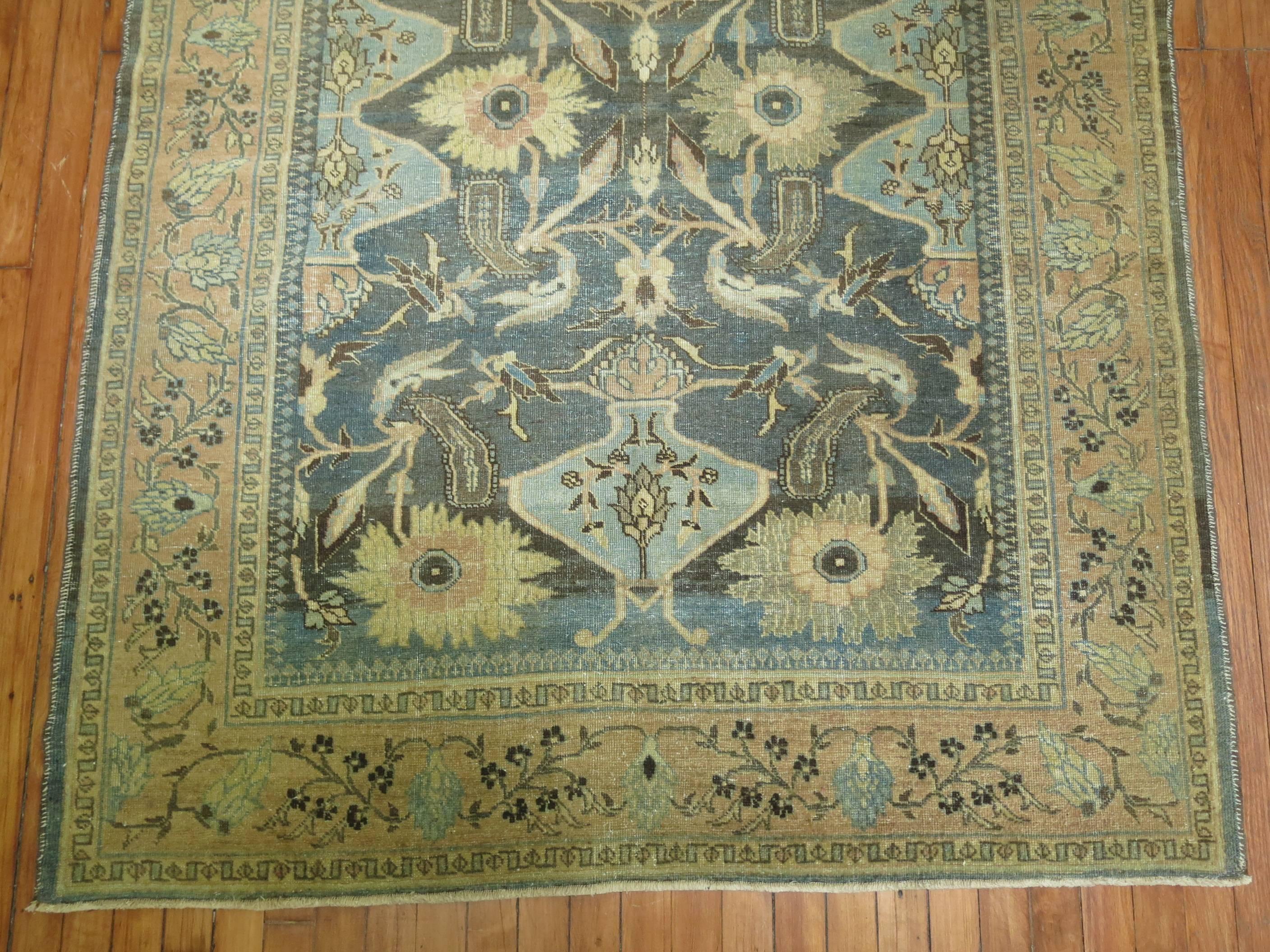 An antique Persian Tabriz rug accents in green, blue and sand.