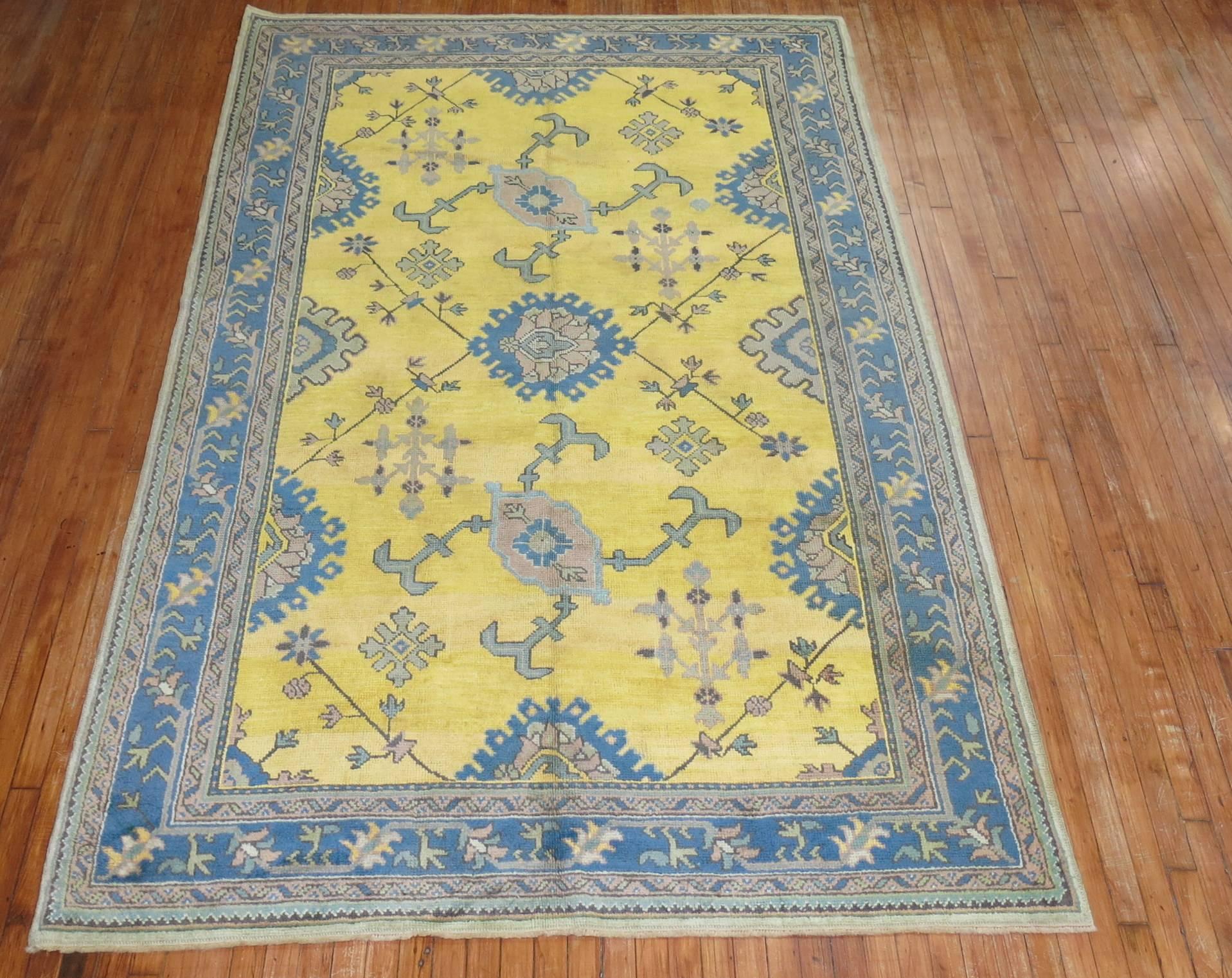 An antique Turkish Oushak with an unusual bright sunny yellow ground outlined by teal border.

Measure: 6'1