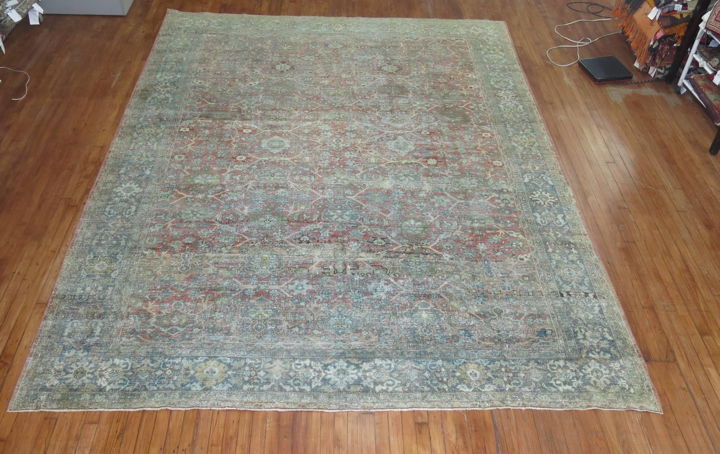 Room size early 20th century antique Persian Mahal rug with an all-over design in faded terracotta's and sea foam green. Really chic!

Measures: 9'4