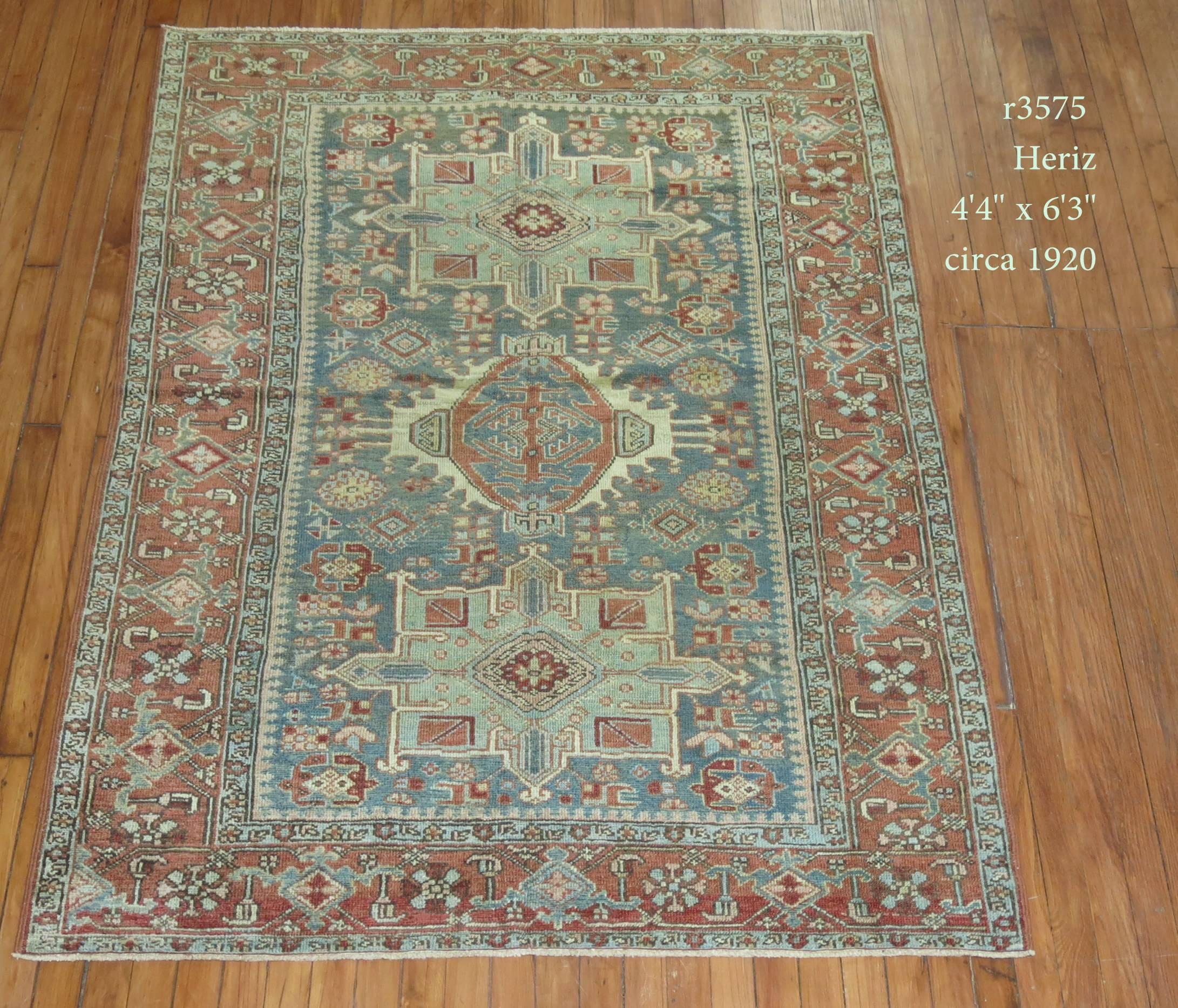An early 20th century Persian Heriz Karadja rug in earth tones. Gray, green, brick, light blue are the dominant colors,

circa 1920. Measures: 4'4