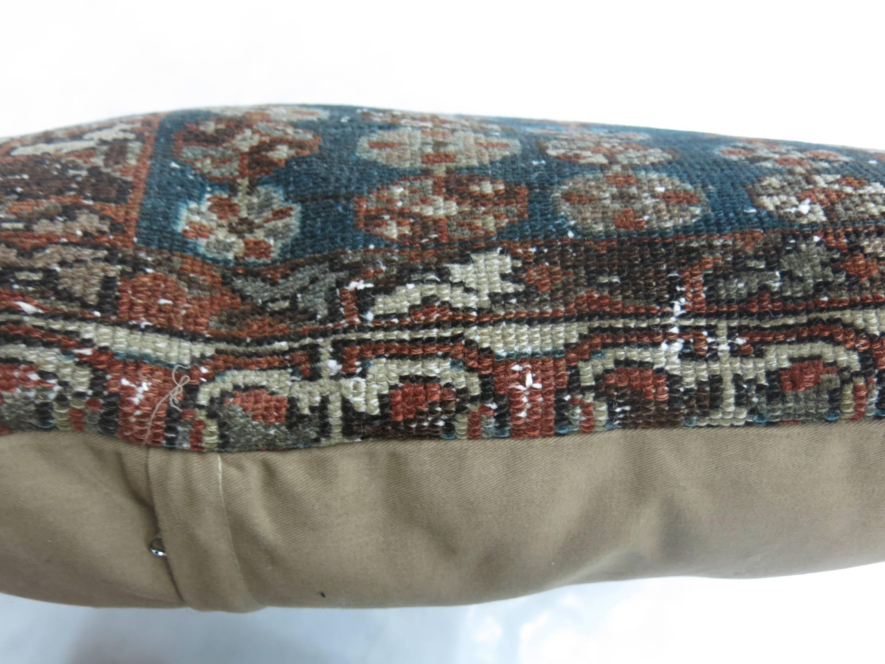 A large pillow made from a Persian Malayer rug in brown and navy

15'' x 21''