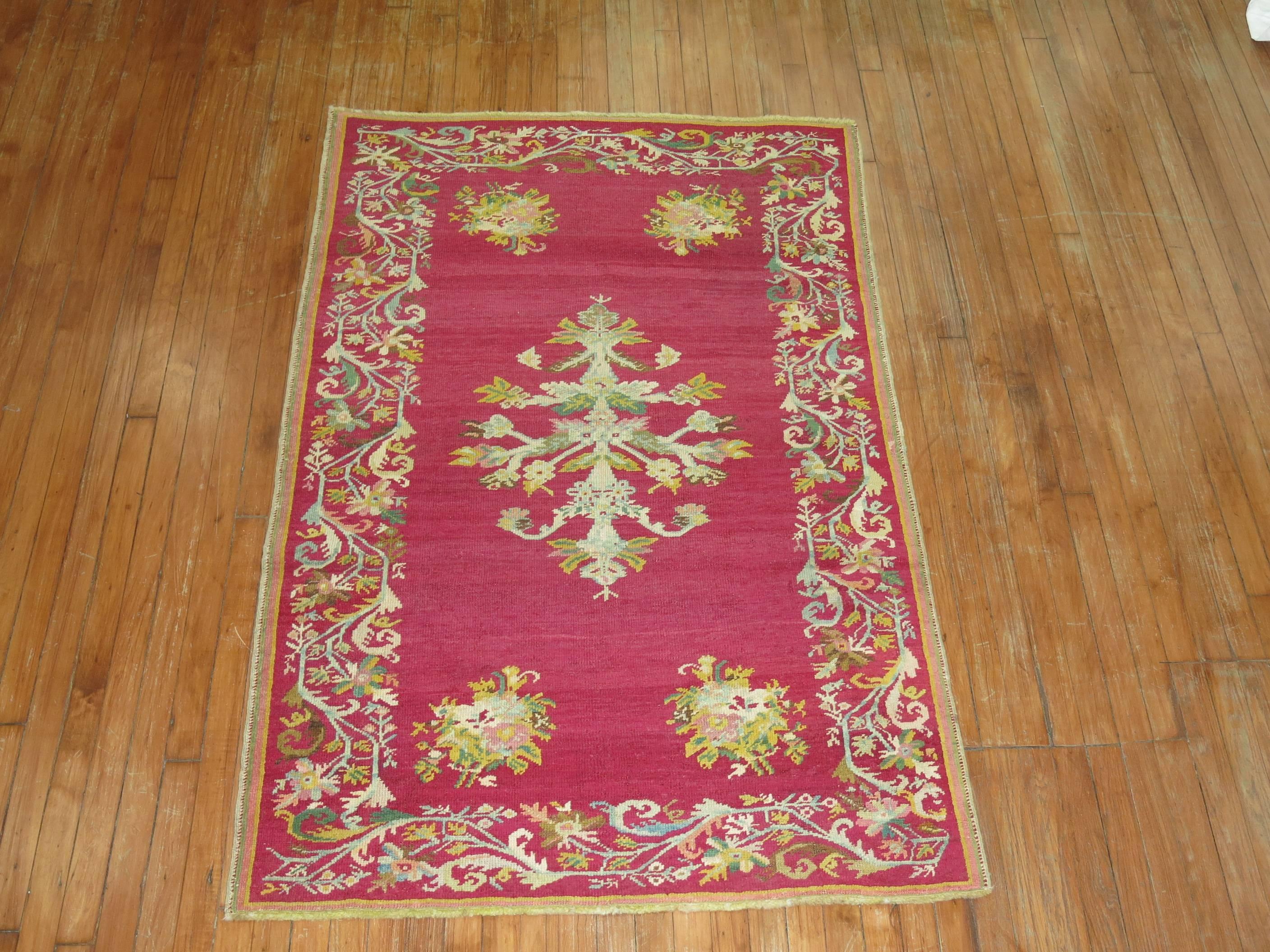 Antique Turkish Ghiordes rug with an enchanting floral palette on a raspberry field

circa 1900. Measures: 3'9