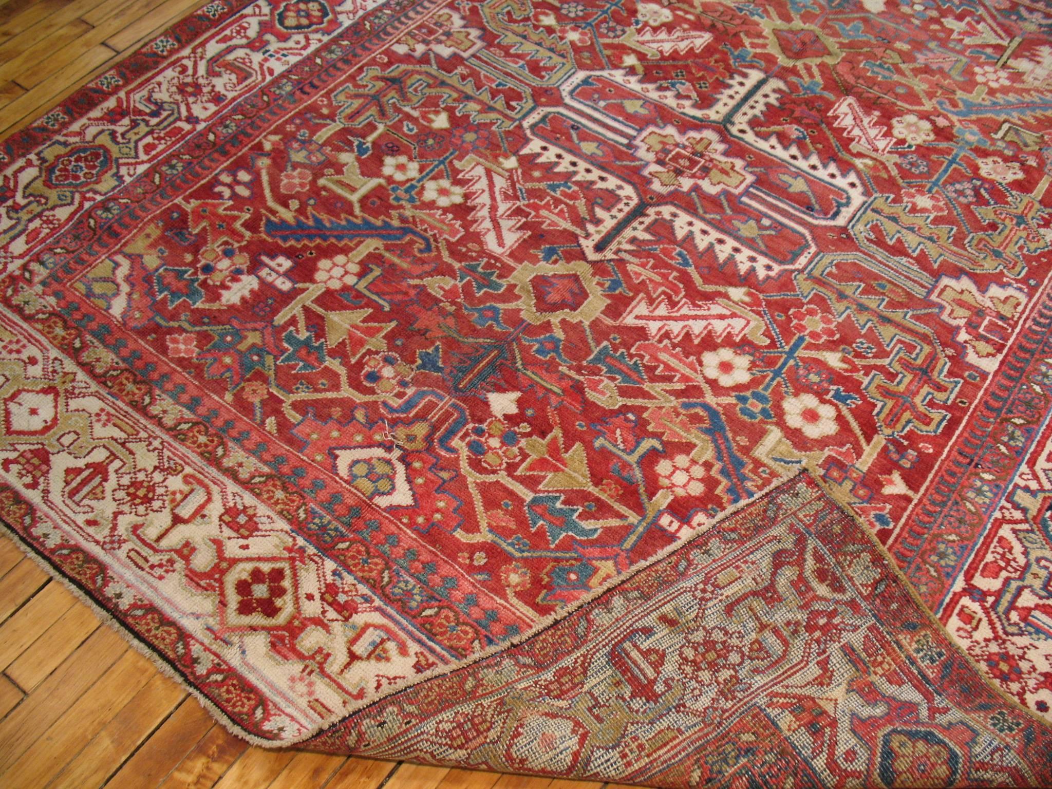 Rare size Persian Heriz carpet in predominant reds, ivory, icy blue and green. The field is a vivid red, the border is ivory. Full Pile Condition

7'3'' x 8'2'' circa 1920