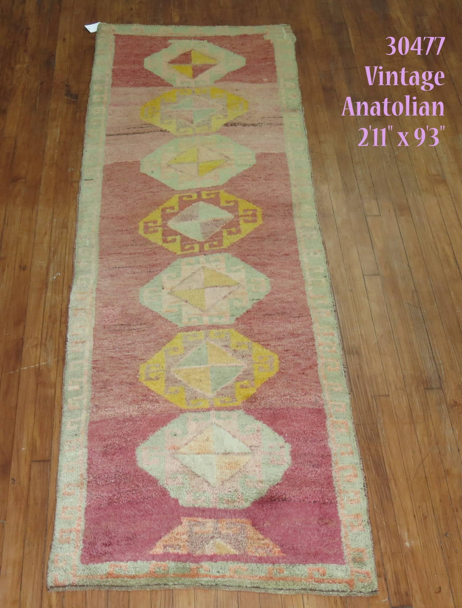 Mid 20th Century Turkish Anatolian runner with a thick medium pile throughout reminiscent of 20th century moroccan rugs. Pink Magenta Color Field. mint green and yellow accents

2'11'' x 9'3''