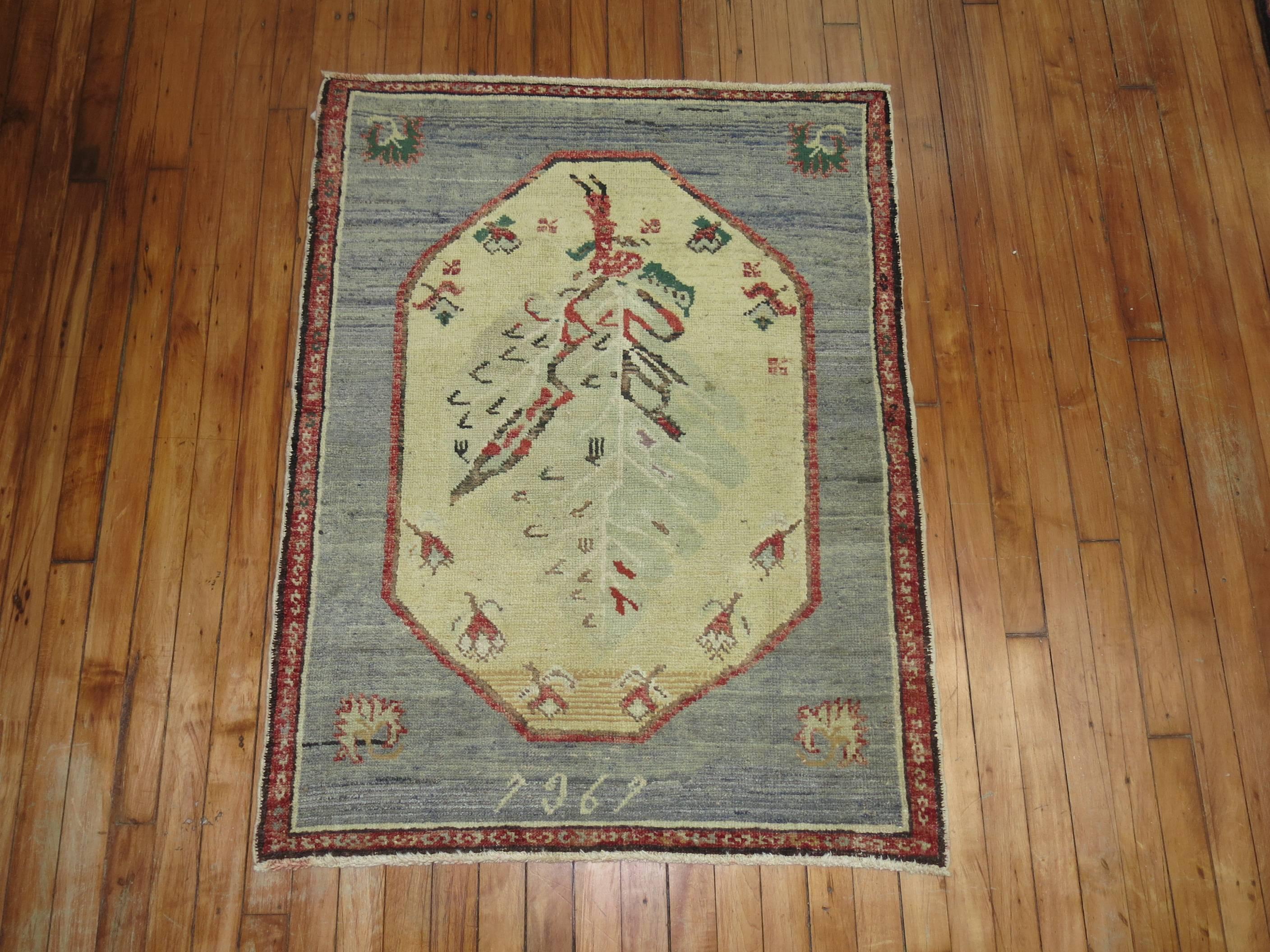 Vintage Turkish Anatolian rug with a trapezoid shaped medallion on a grayish blue field, accents in beige, rust red and green.

Measures: 2'11