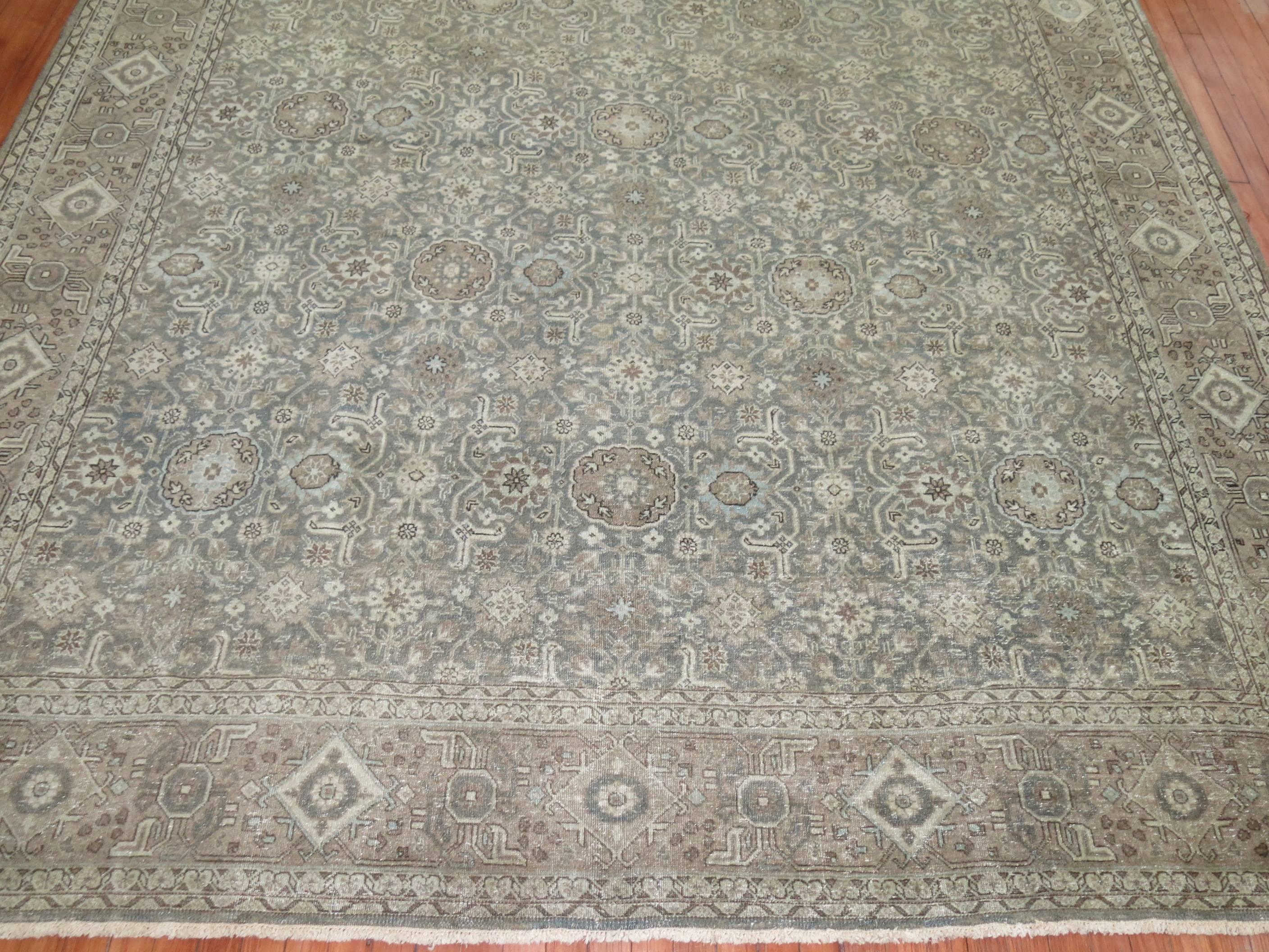 Antique Persian Tabriz rug in silver, green blue and brown hues.

Measures: 9' x 12'8''.