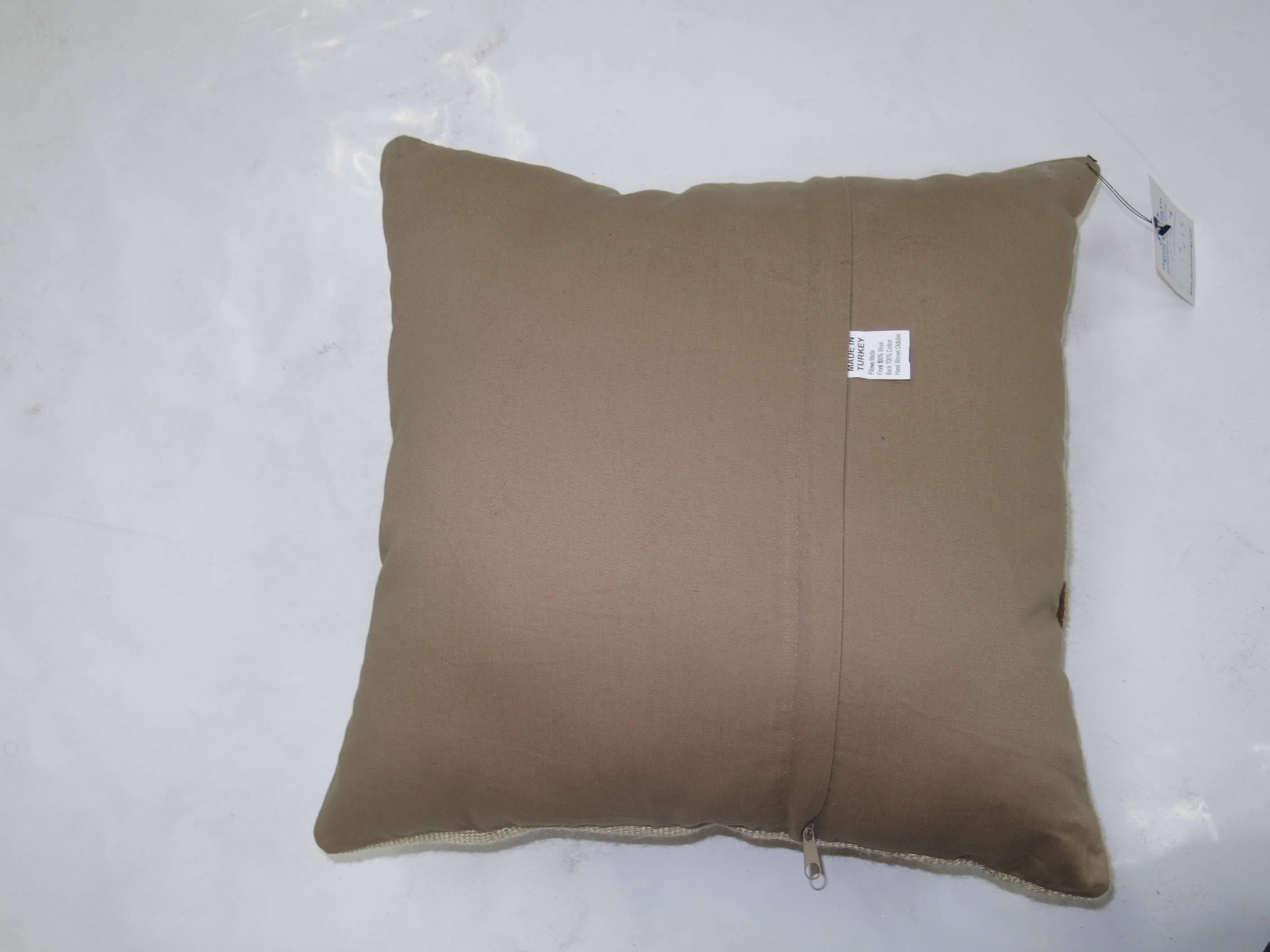 Pillow made from a mohair rug. Solid ivory with brown motif towards one end. Zipper closure and foam insert provided.