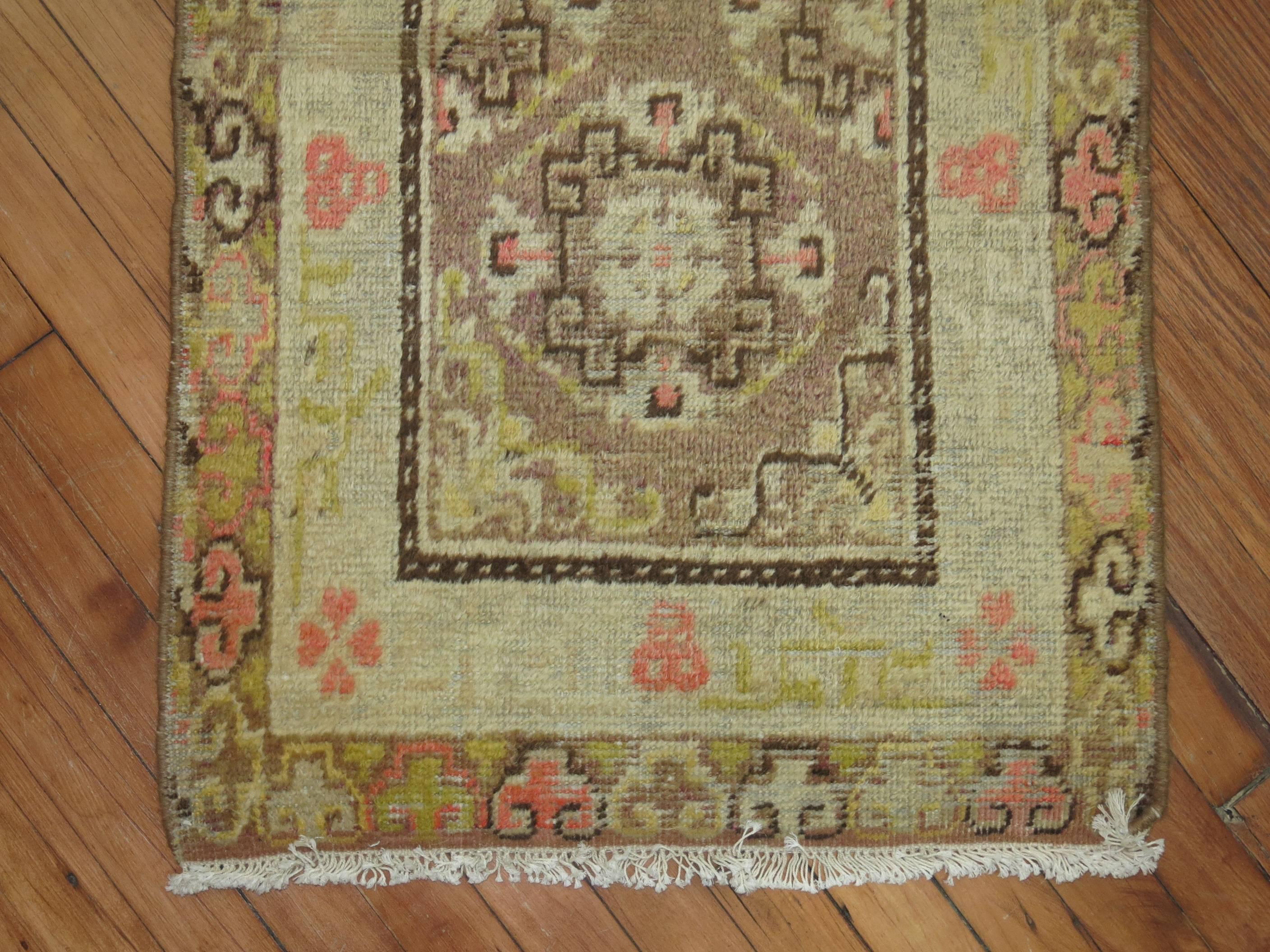 Cute little vintage Khotan rug. Khotan rugs usually are found in gallery sizes and rarely do you see them this small.