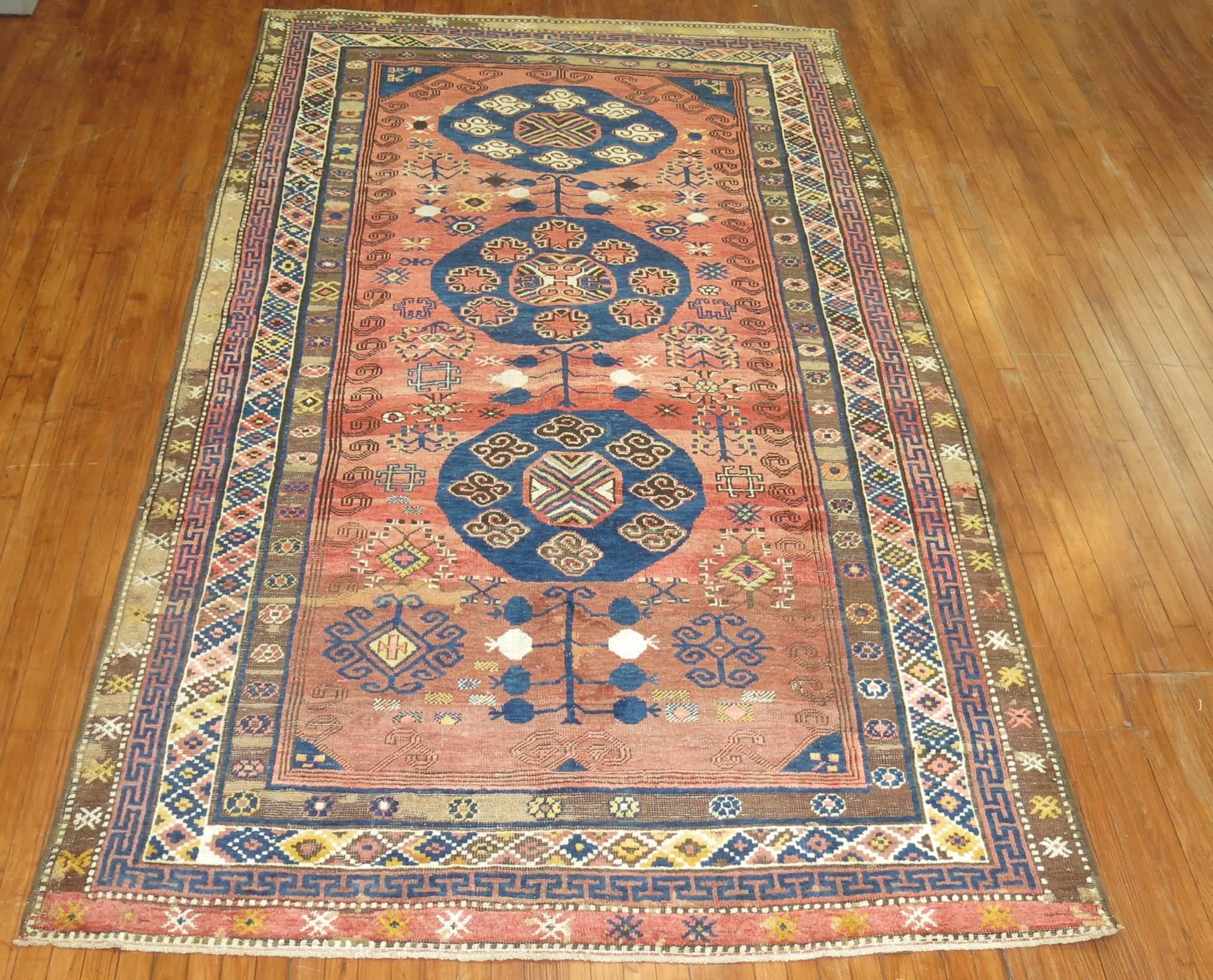 Mid-20th century Turkish village rug derived from a 19th century Asian Khotan rug. The pile construction is thicker giving the rug more durability and longevity. The weave did an amazing job with colors and graphic on the rug.