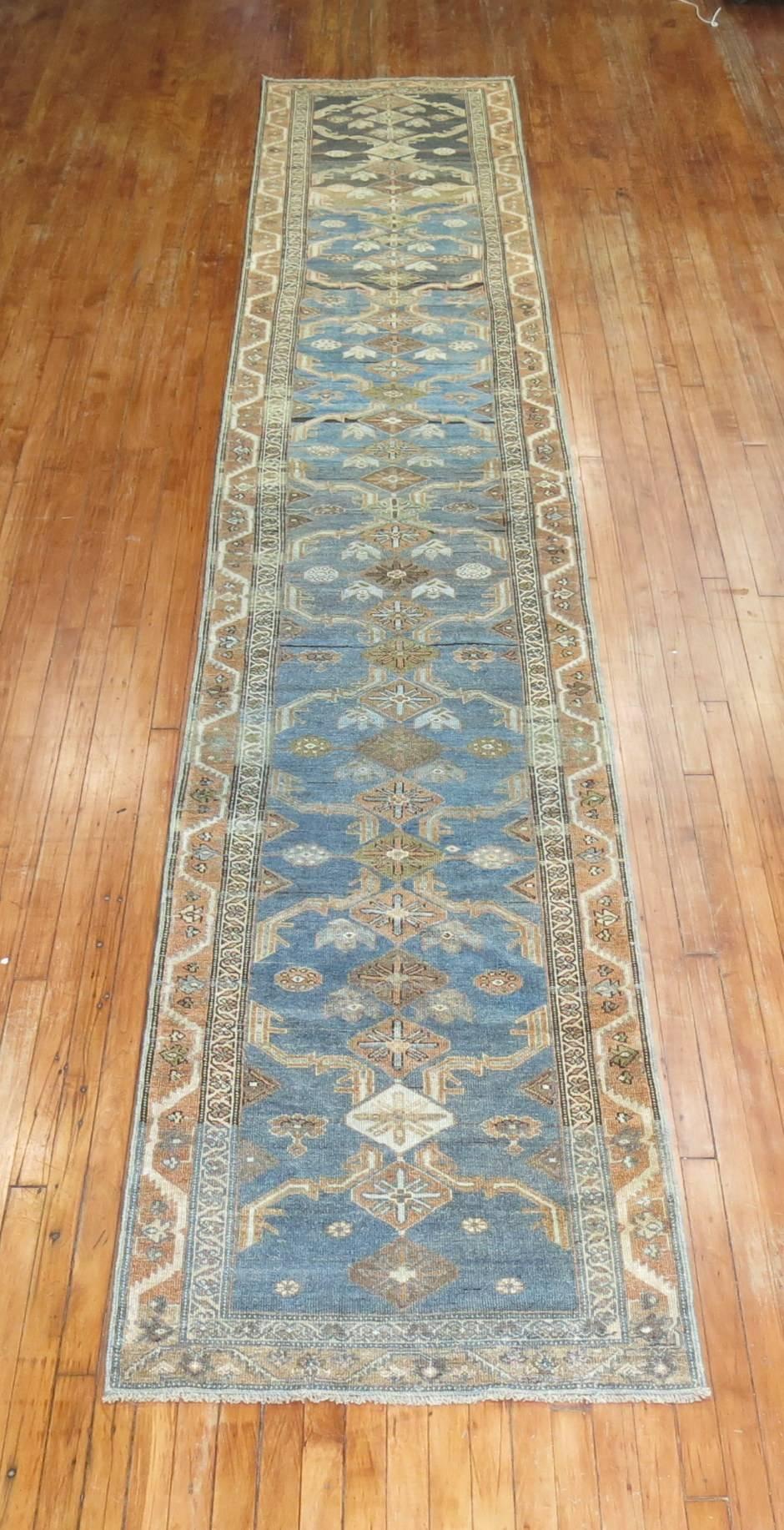 An early 20th century Persian Malayer runner in predominant blues and brown,

circa 1920, measures: 2'9