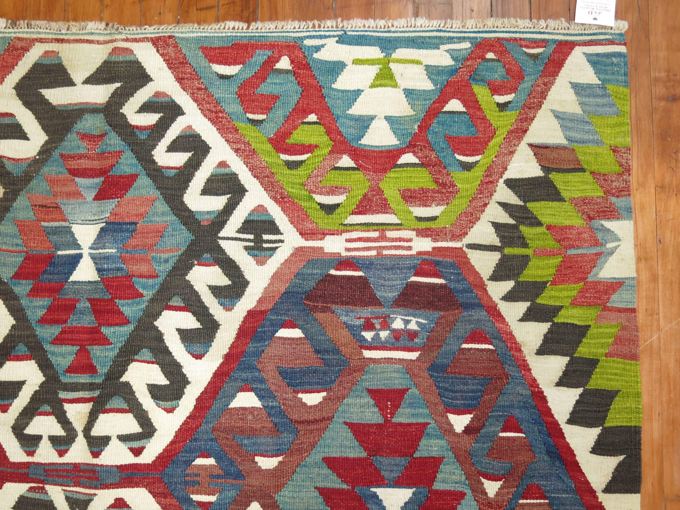 Vibrant colored geometric Turkish Kilim from the mid-20th century.

Measures: 5'2” x 9'10”.