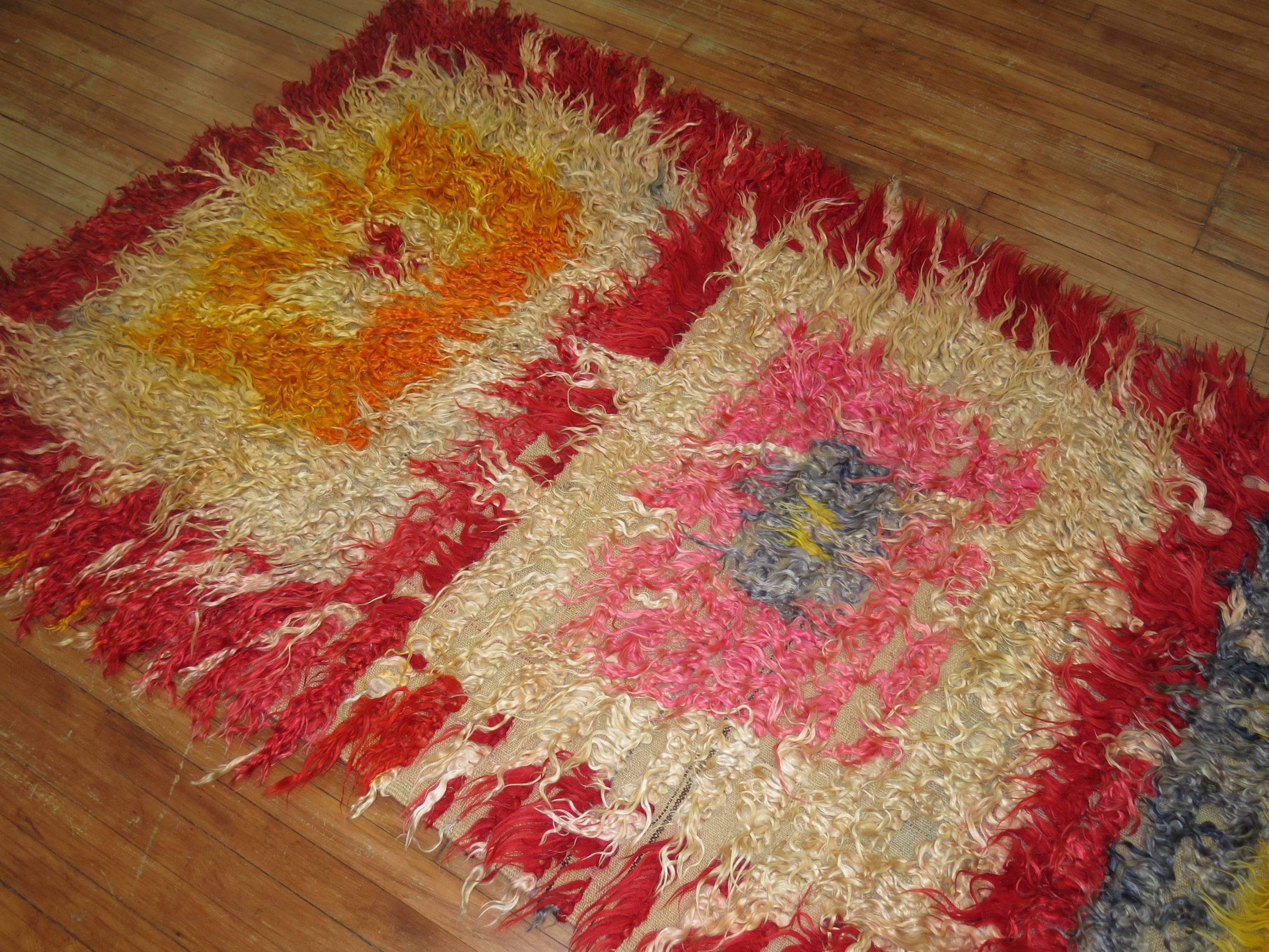Wild Turkish Tulu Shag wide runner with dominant bright red, pink, yellow, orange accents

Measures: 4' x 9'7