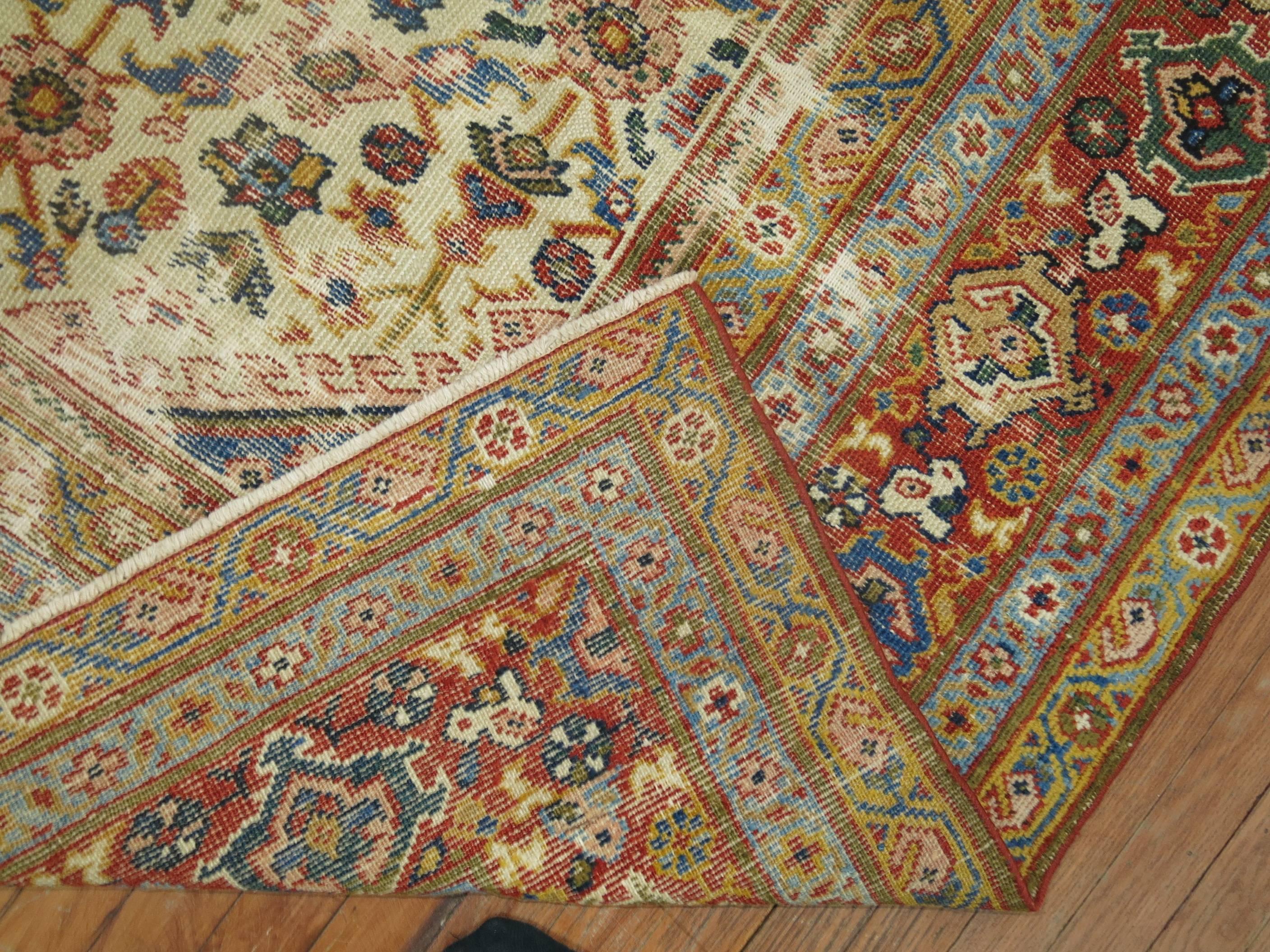 An early 20th century distressed Persian Mahal rug. Ivory field, tomato red border, dominant accents in light blue, gold and coral.

Measures: 8'4