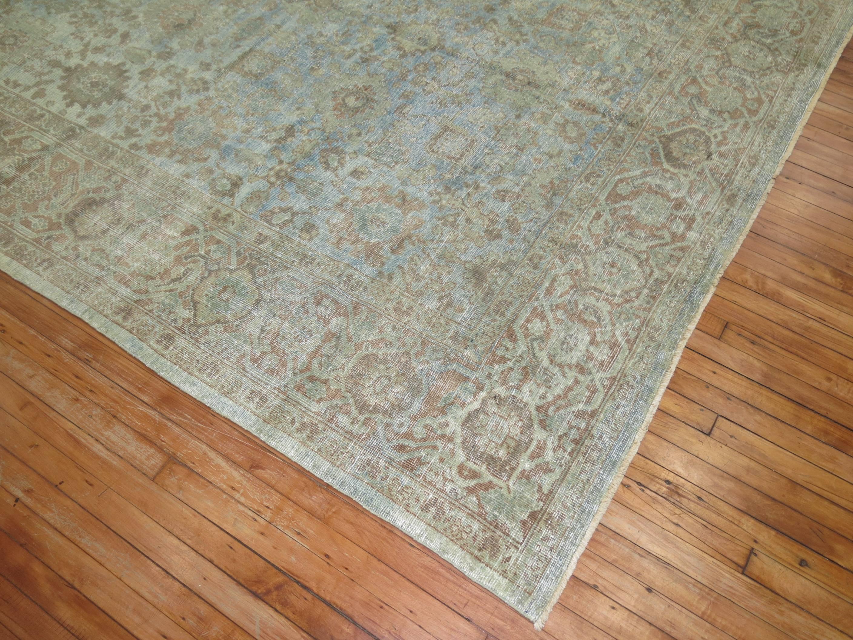 An early 20th century decorative Persian Mahal rug in a predominant unique watery blue tone. Accents in light green and soft brown. Perfect amount of wear with incredible texture and patina.

Measures: 8'4