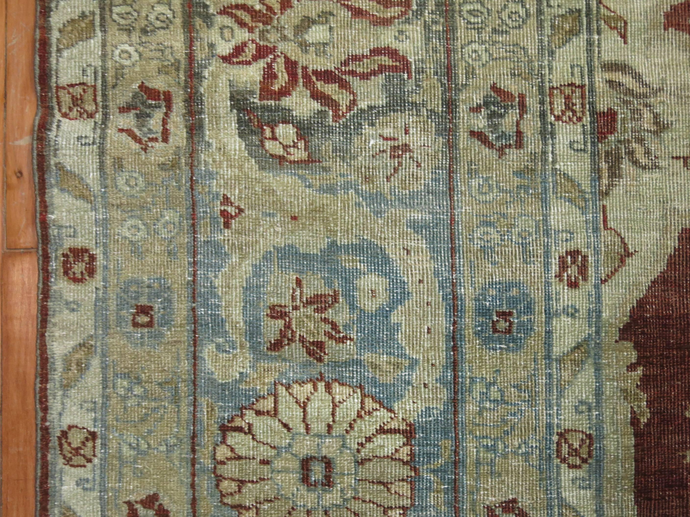 Antique Persian Tabriz rug with a burgundy field, predominant accents in icy blue and gray found in the medallion, field and border. 

7'2'' x 9'7'' circa 1930