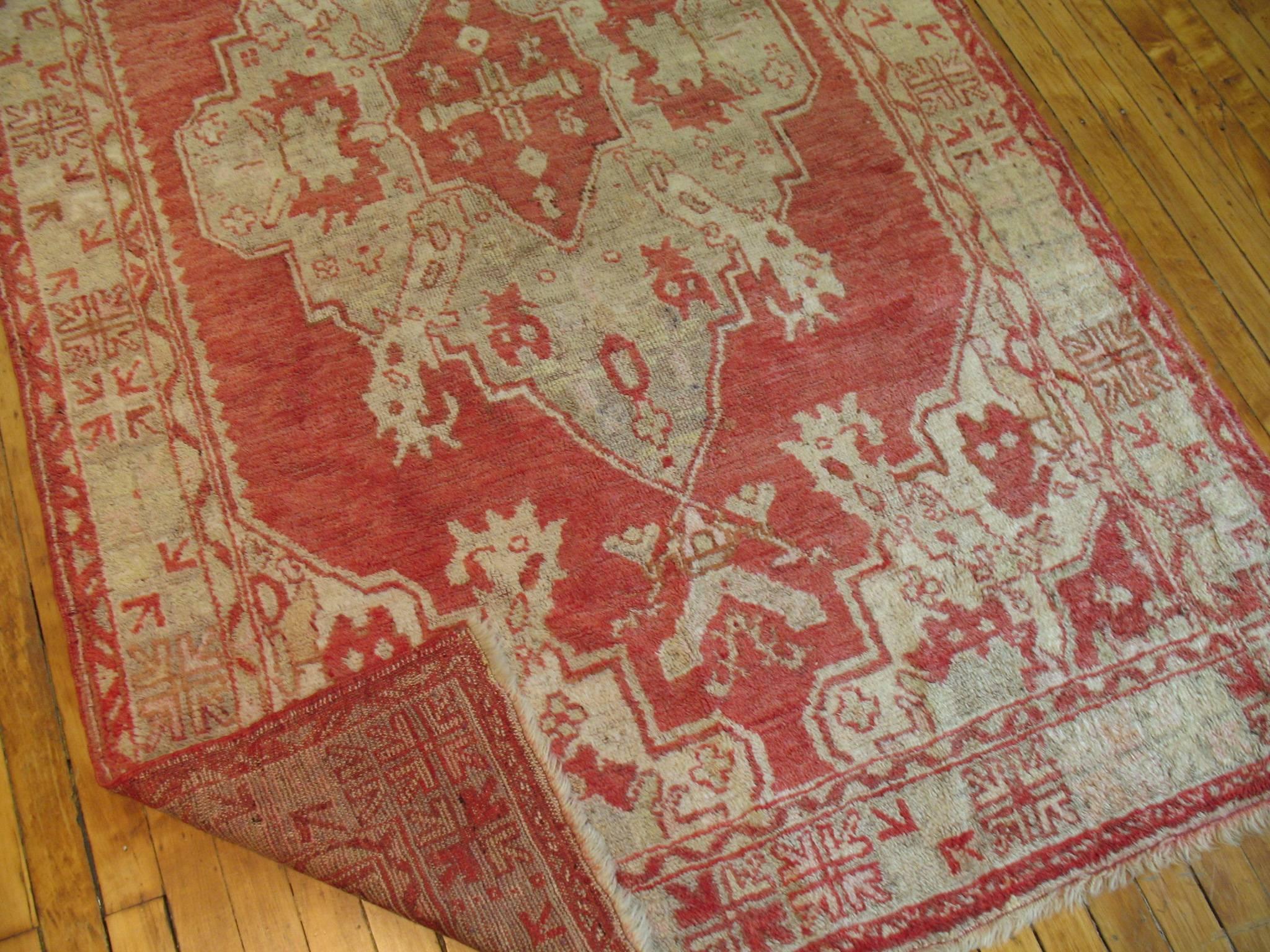 Accent size Turkish Oushak rug with a red background accents light green ivory and gray.

Measures: 4'2'' x 6'9''.